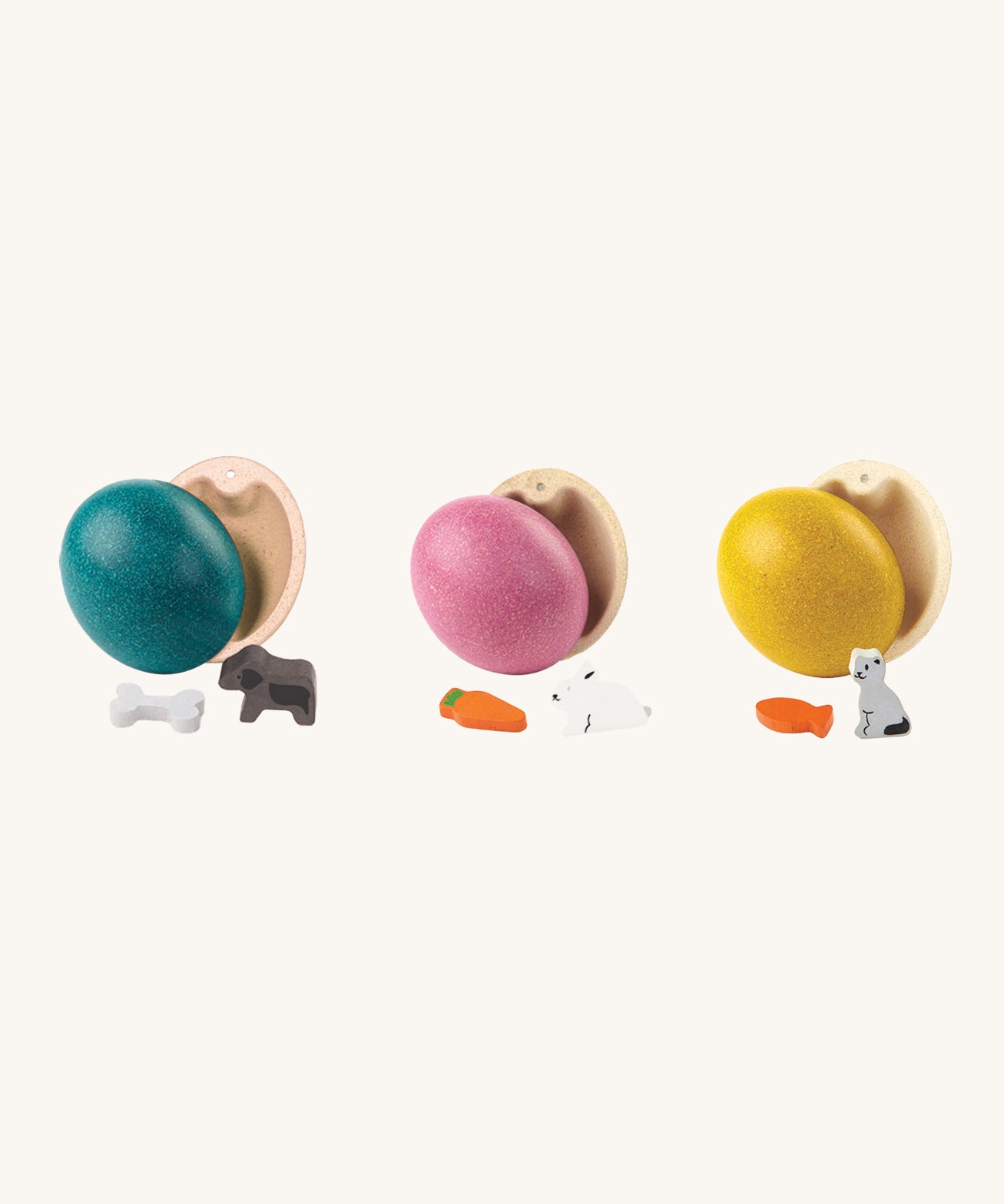 PlanToys Eggs are a fun, plastic-free, Easter egg alternative for little ones. Each egg comes with a little animal figure inside. These are a blue egg with a dog and bone, a pink egg with a rabbit and carrot, and a yellow ess with a cat and a fish. The image is on a cream background