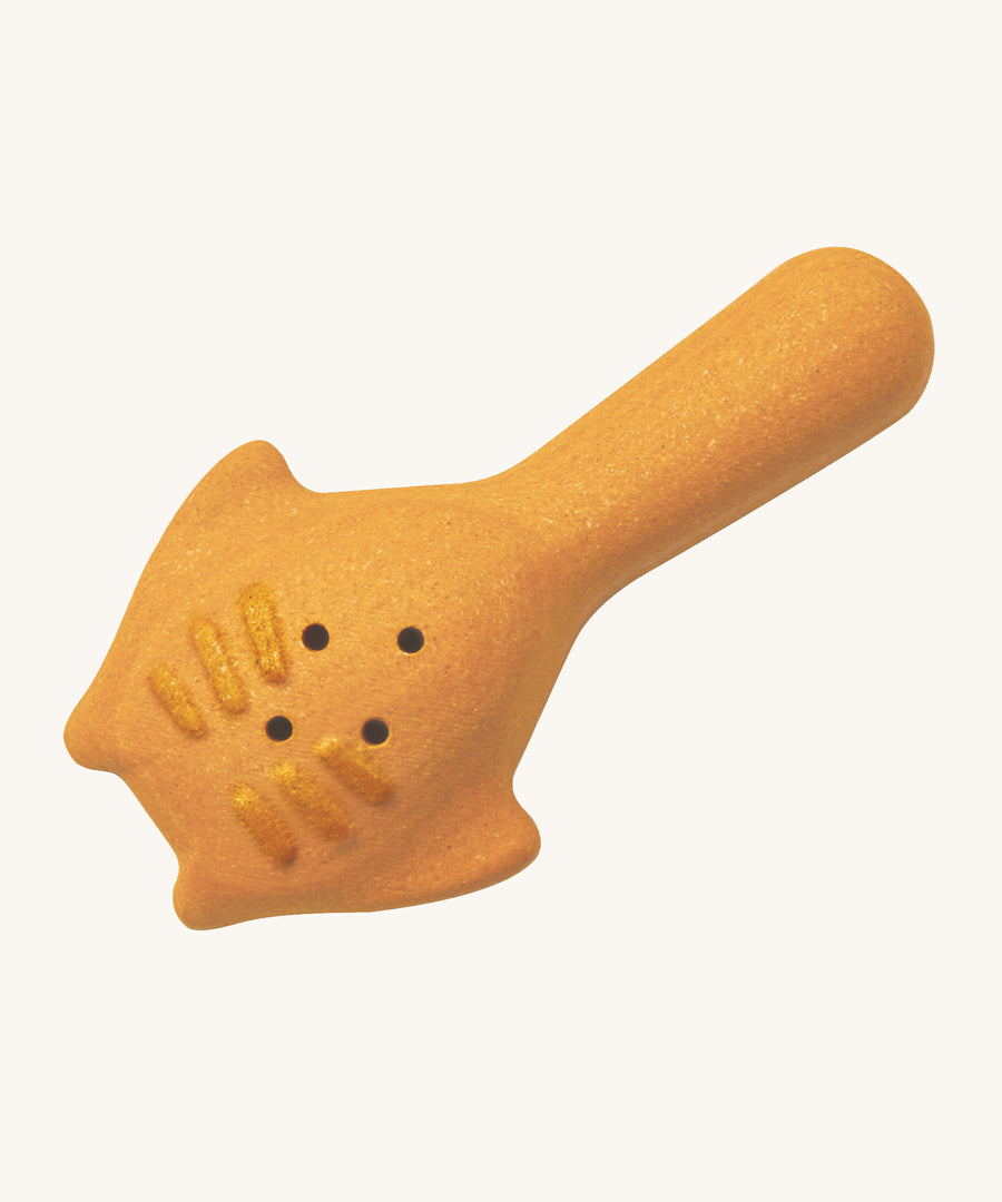 The back of the yellow scoop from the PlanToys Sand Play set. The scoop has small holes for water to pass through, and raised lines on the back. The scooper looks like  Mantaray from the ocean