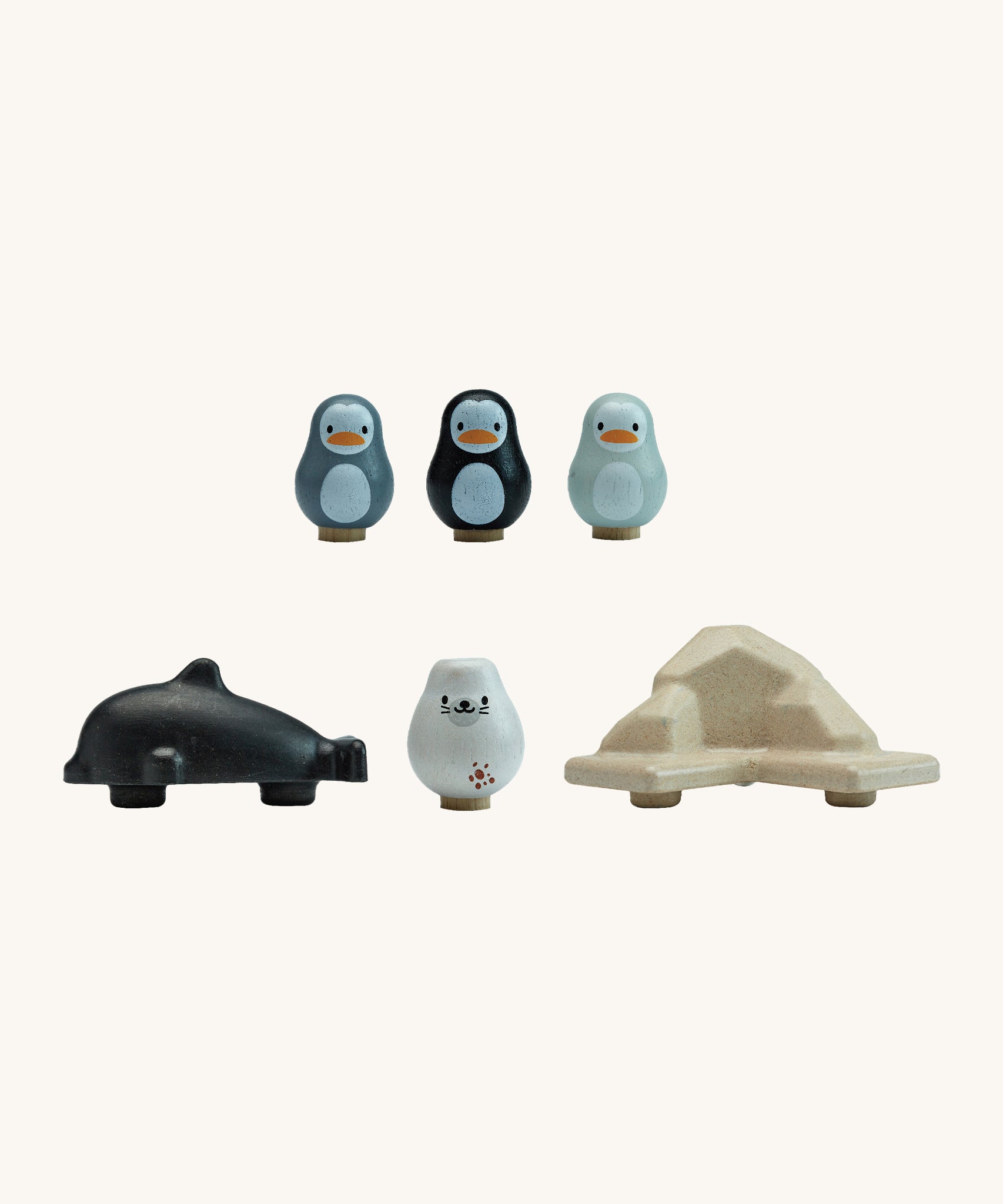 Pieces of the plan toys plastic free finding penguin family board game lined up on a white background