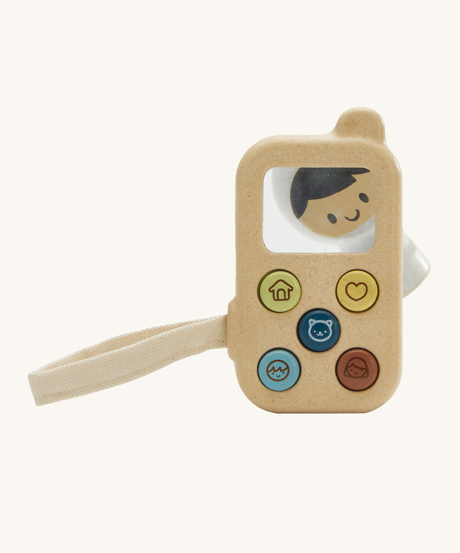 PlanToys Baby's First Phone toy, offers a fun and sensory experience for little ones. This toy is made from wood and has 5 buttons on the front with friendly images. There is also a magnifying glass square so little ones can explore their surroundings in more detail. The image is on a cream background