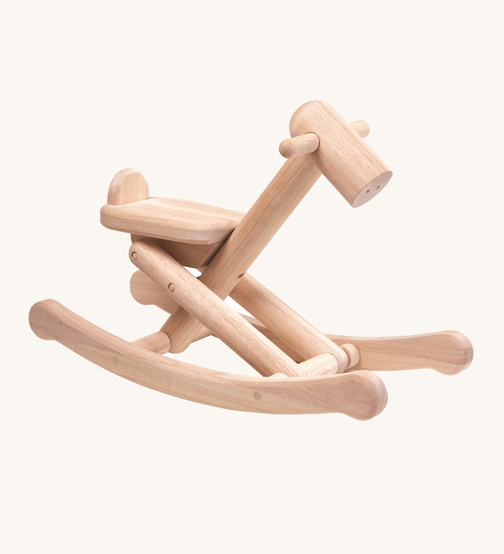 PlanToys Foldable Rocking Horse, made from wood with the beautiful wood grain showing on each piece. On a cream background