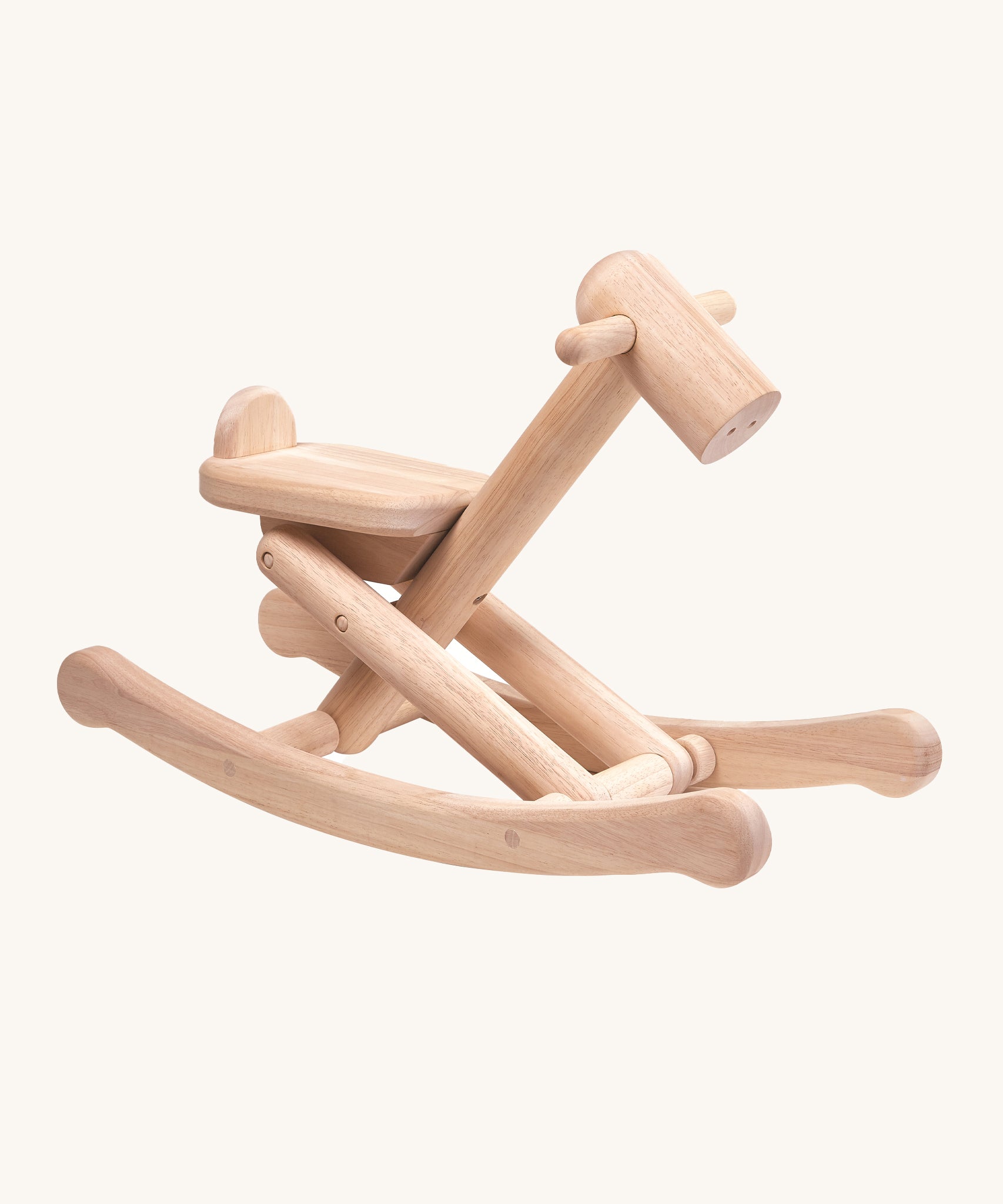 PlanToys Foldable Rocking Horse, made from wood with the beautiful wood grain showing on each piece. On a cream background