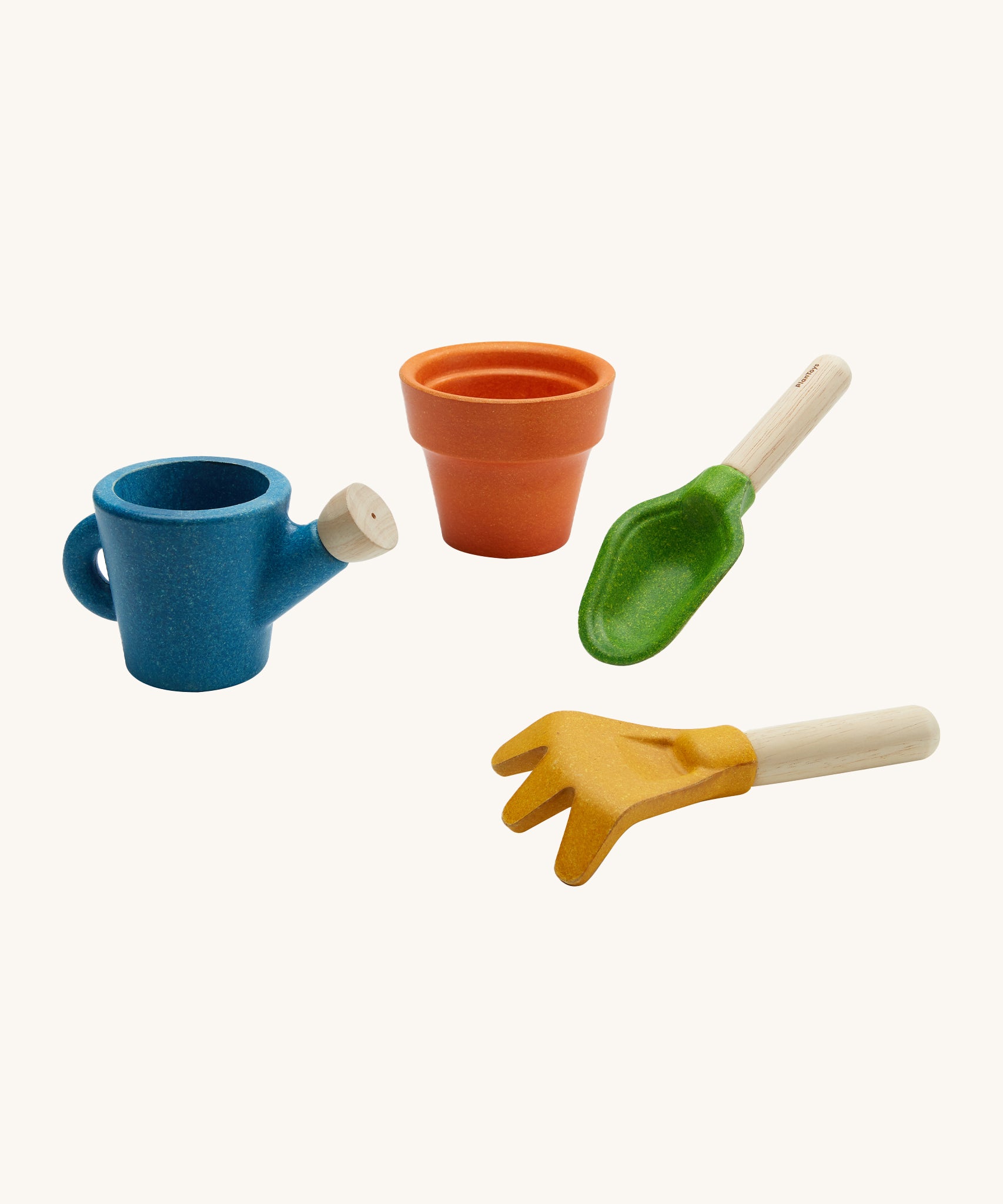 PlanToys Gardening Set is a wooden role play set with a brown plant pot, a green trowel, and yellow rake and a blue watering can. Each piece can be used in messy play and the watering can has a small hole in the spout to allow water to pour through