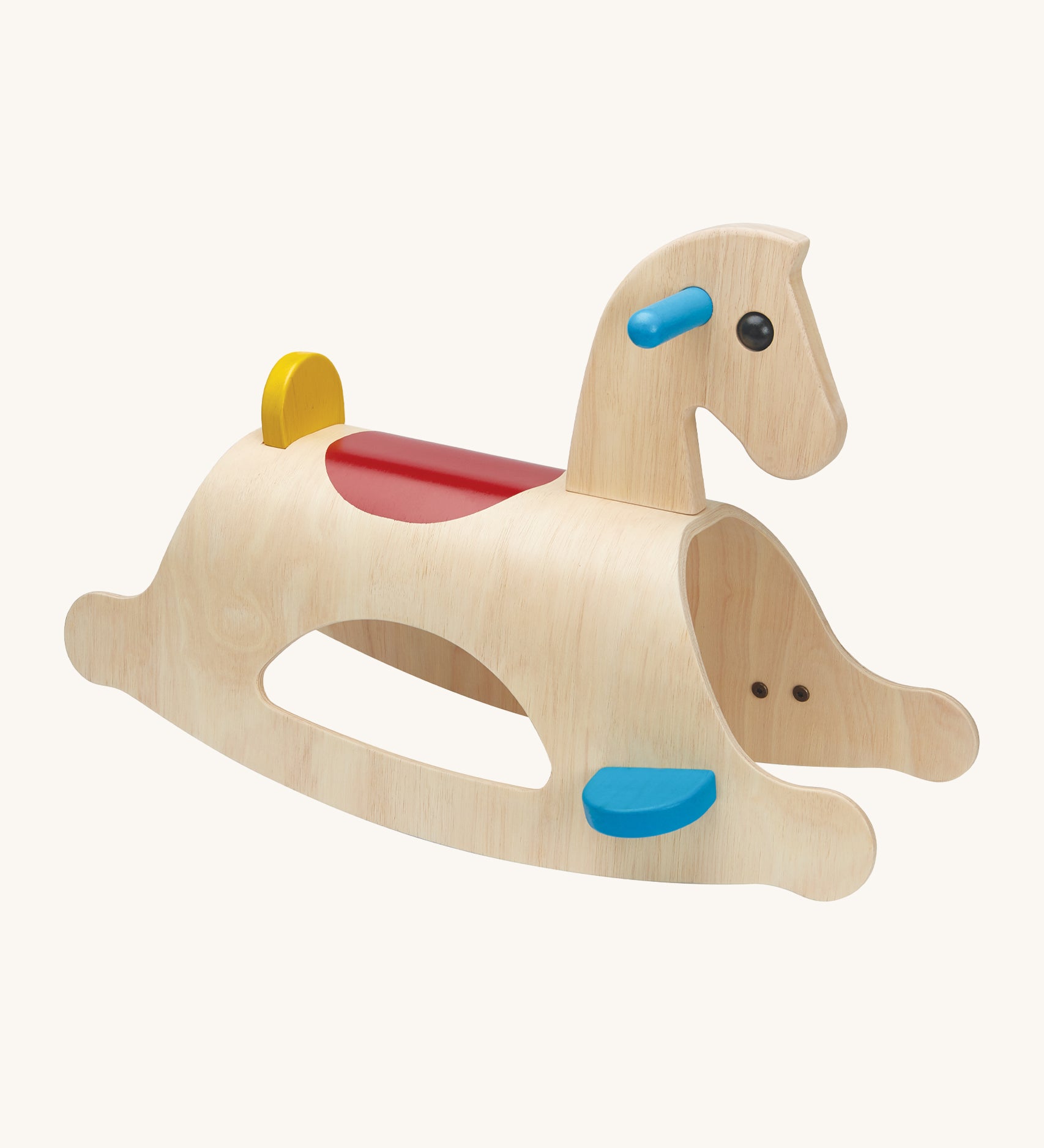 PlanToys Palomino Rocking Horse is a great first rocking horse for children. The rocking horse is made from wood, and shows the natural wood grain. Blue foot plates and handles, a red saddle section on the back of the rocking horse, and a small yellow back support. The mage is on a cream background