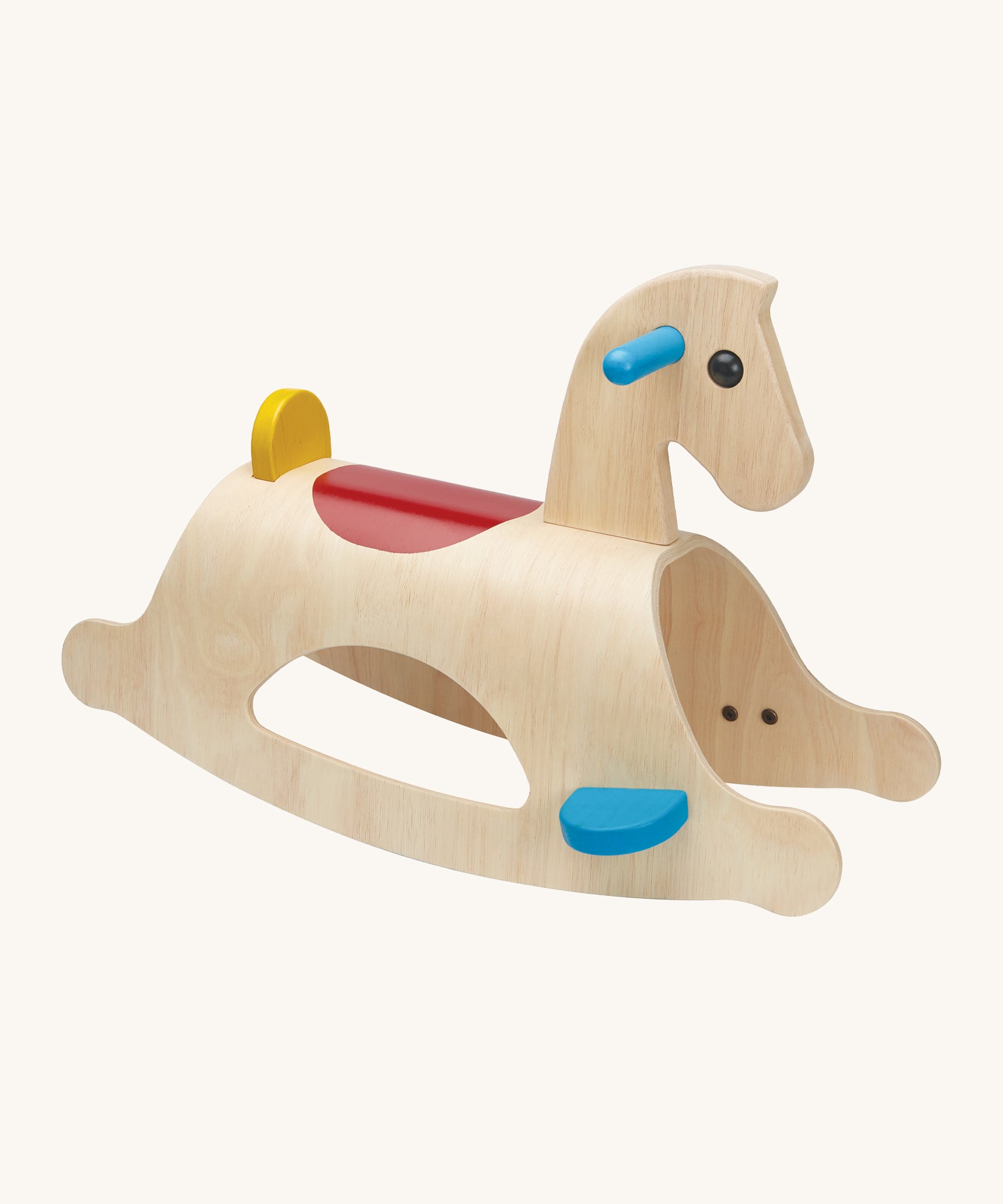 PlanToys Palomino Rocking Horse is a great first rocking horse for children. The rocking horse is made from wood, and shows the natural wood grain. Blue foot plates and handles, a red saddle section on the back of the rocking horse, and a small yellow back support. The mage is on a cream background