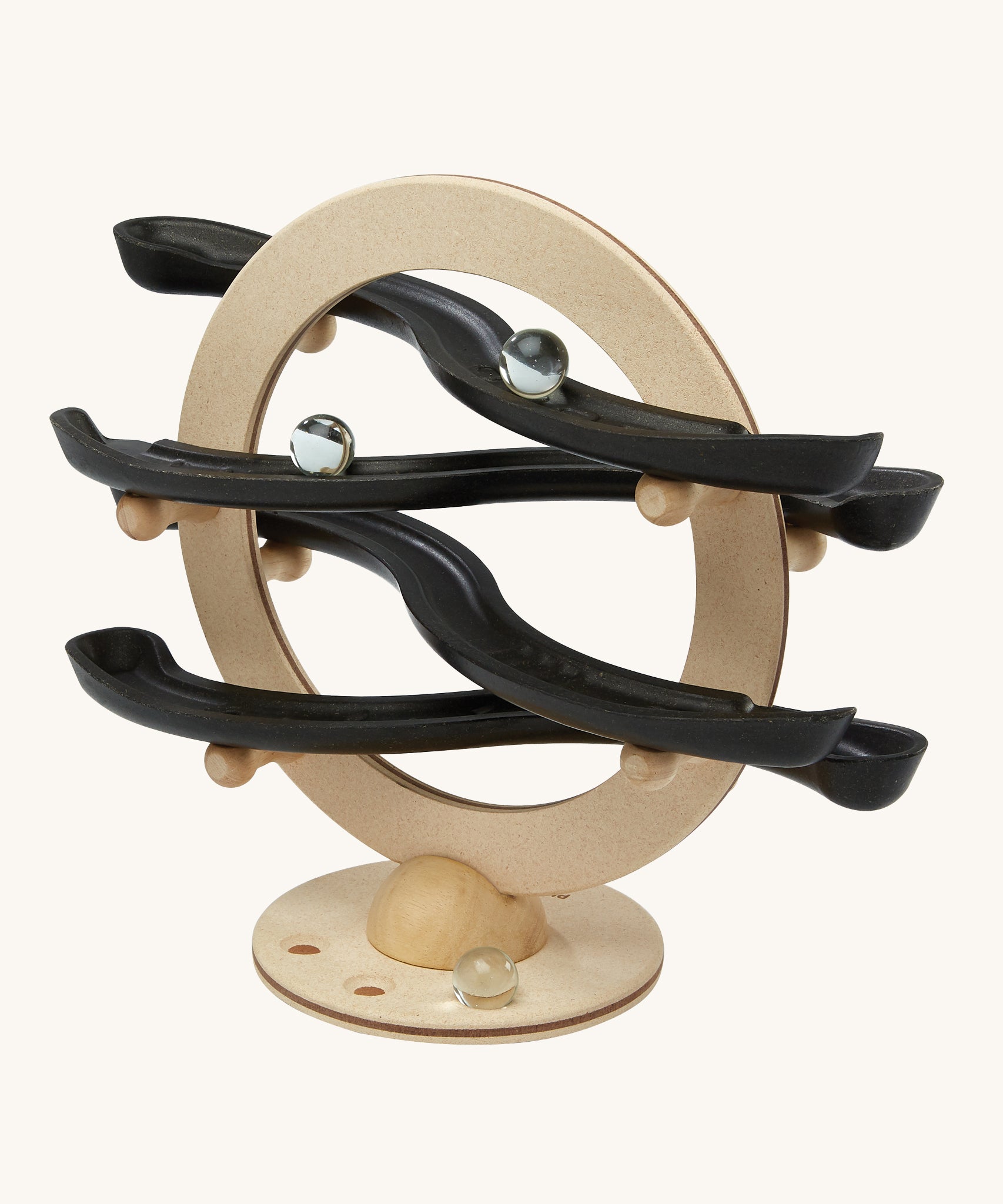 The PlanToys Curvy Click Clack game is a wooden marble run toy with a circle base and 4 wobbly tracks all made from PlanWood. The image shows marbles going down the track on a cream background