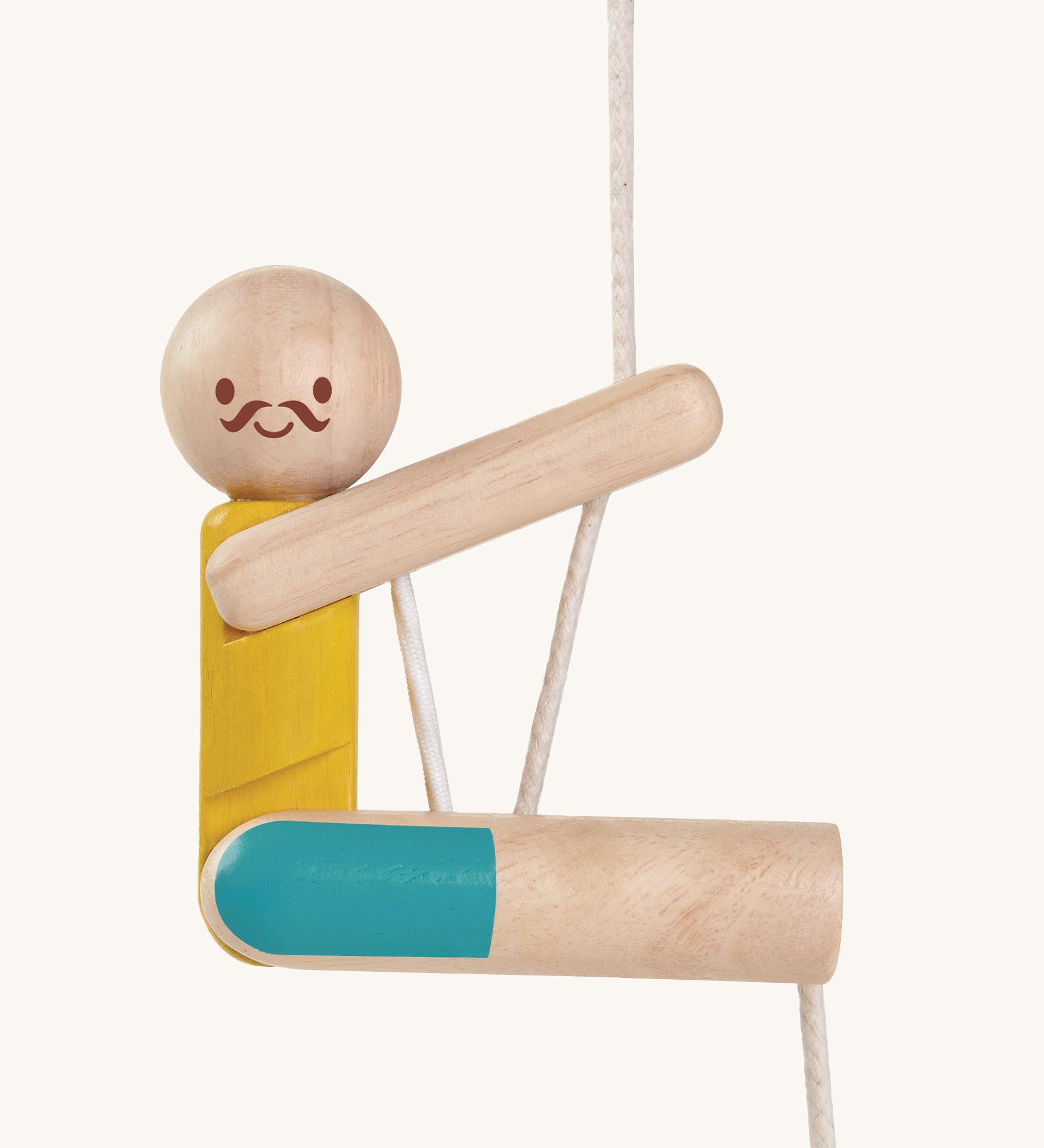 A closer look at the PlanToys Rope Climbing Acrobat. The figure has a happy, smiling face and mustache , a yellow painted top and blue painted shorts. The PlanToys paint is natural and safe. The image is on a cream background.