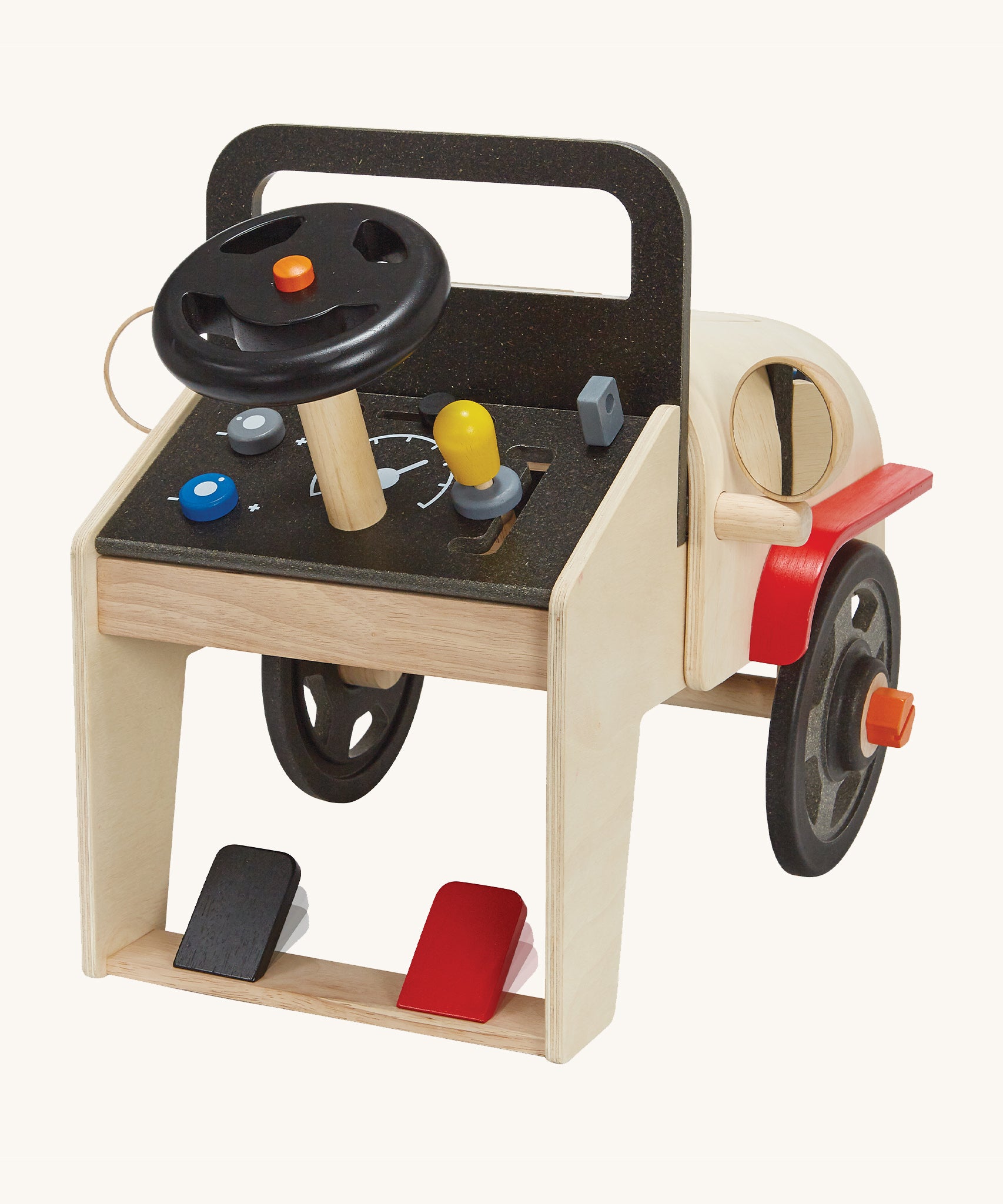 The back of the PlanToys Motor Mechanic showing the push-able black and red pedal at the bottom, the steering wheel, gear stick, key ignition and dials, on a cream background