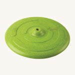 The Green PlanToys Saucer Disc Swing without the rope, showing the smooth Rubberwood texture and design of the swing seat. On a cream background