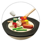 A closer view of the PlanToys BBQ play food which includes wooden bbq food on skewers, the salt shaker and the basting brush