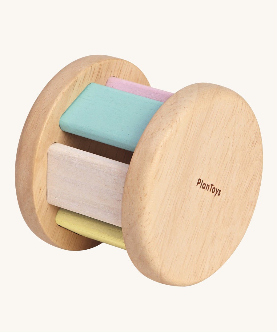 The PlanToys Pastel Roller, is a fun push and pull roller toy for babies and little ones. The roller comes with two natural wooden sides, with pastel coloured slats. The image is on a cream background