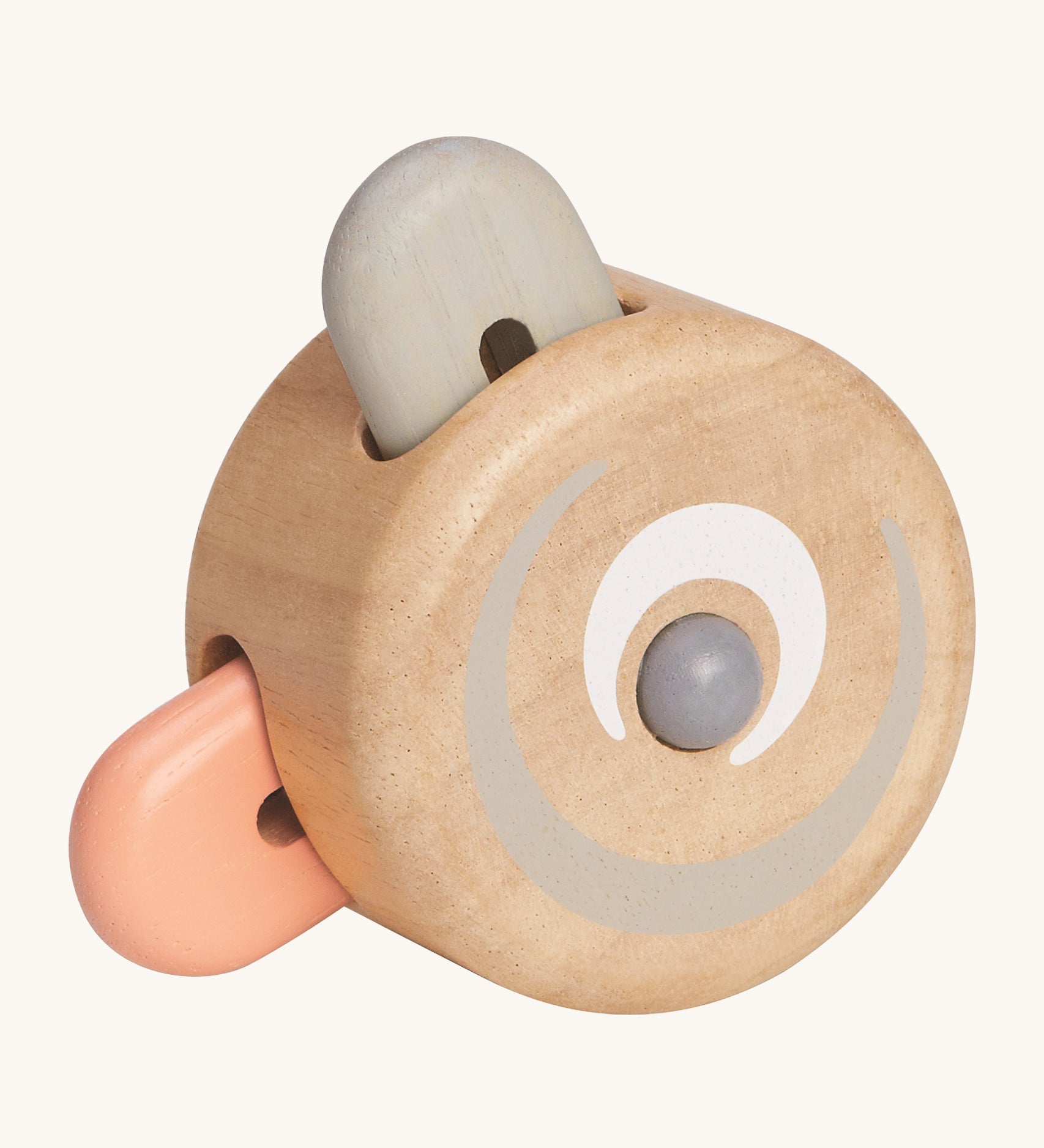 The PlanToys Wooden Pastel Peek-A-Boo Roller is a perfect rolling and push toy for babies and little ones. The round roller has two wooden teddy bear ear shaped pieces, one in peach and one in grey, that pop inside the natural wooden roller when rolled along the ground. The image is on a cream background