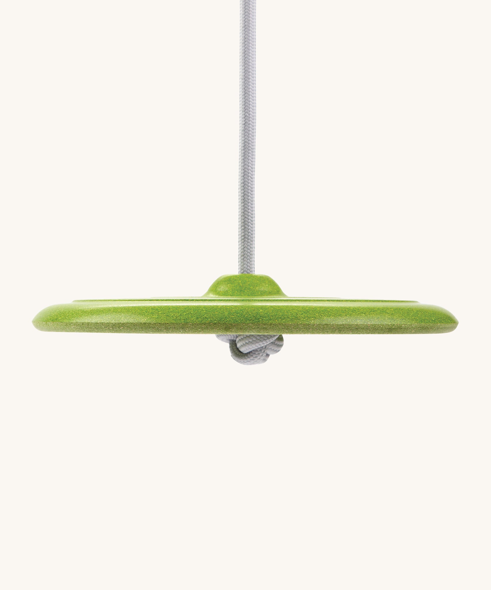 A side view of the Green PlanToys Saucer Disc Swing, showing the rope tied in a knot underneath