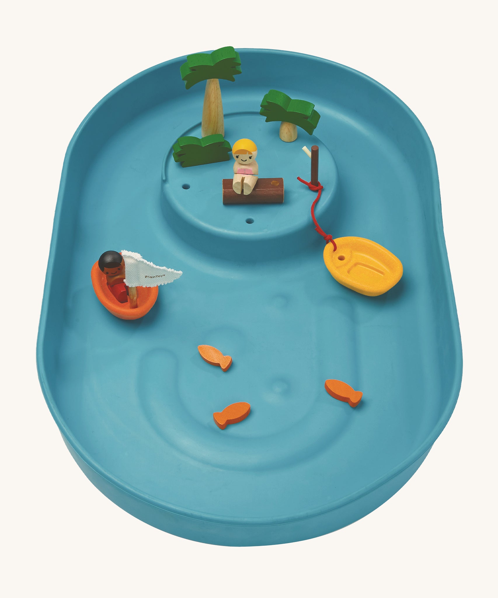 A top view of the PlanToys Water Play Set without water. The inside of the blue tray is textured to give a fun sensory experience, the little fish, boats and people are in the tray. The image is on a cream background