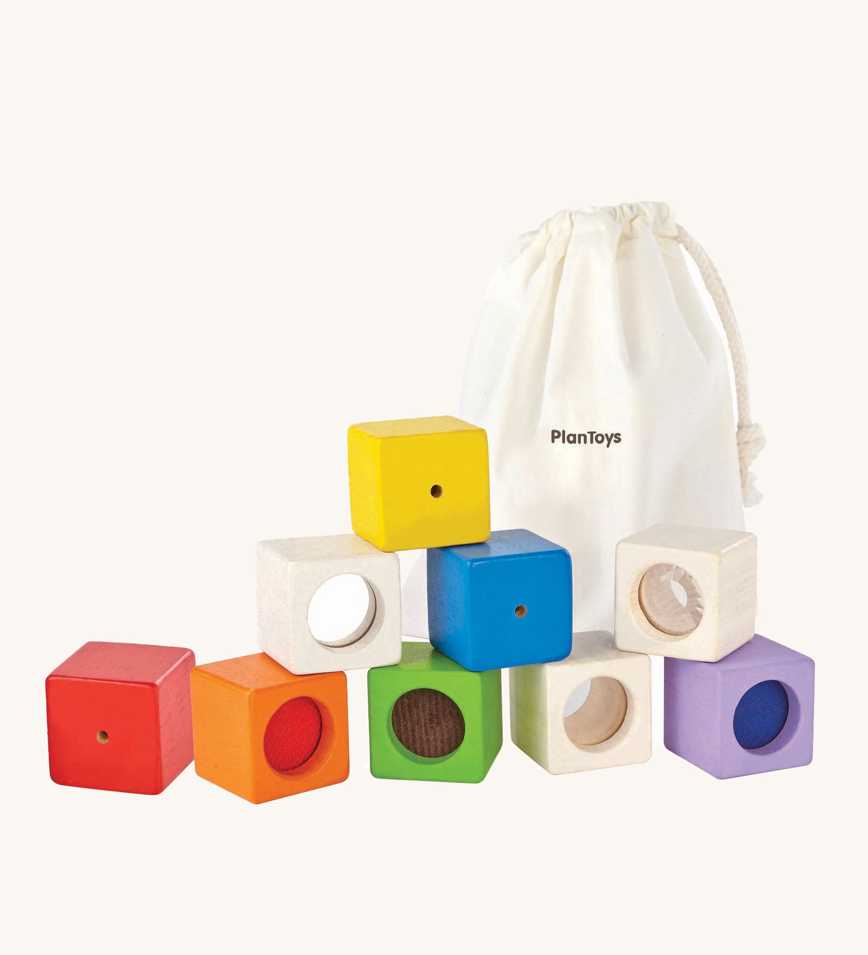 The PlanToys Activity Blocks set, is a wonderful, sensory experience for babies and toddlers. 9 different coluored blocks come with their own sensory part, which includes a differnt texture, sound and colour. These blocks can also be used for stacking games. The image is on a cream background.