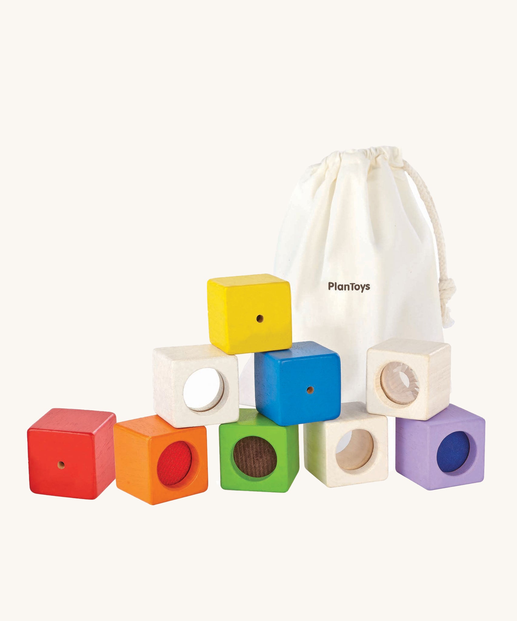 The PlanToys Activity Blocks set, is a wonderful, sensory experience for babies and toddlers. 9 different coluored blocks come with their own sensory part, which includes a differnt texture, sound and colour. These blocks can also be used for stacking games. The image is on a cream background.