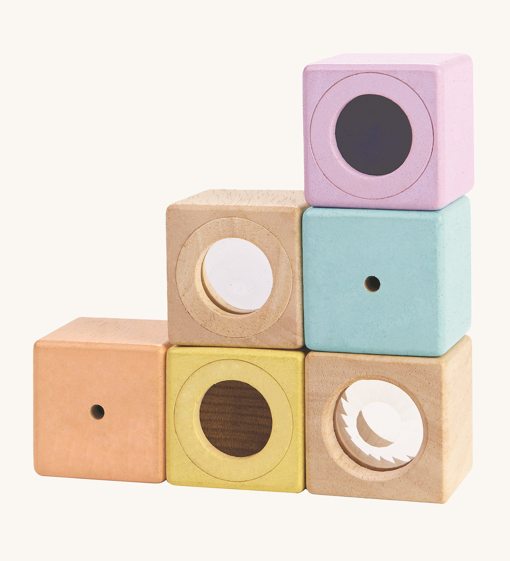 The PlanToys Activity Blocks set, is a wonderful, sensory experience for babies and toddlers. 6 different coluored blocks come with their own sensory part, which includes a differnt texture, sound and colour. These blocks can also be used for stacking games. The image is on a cream background.