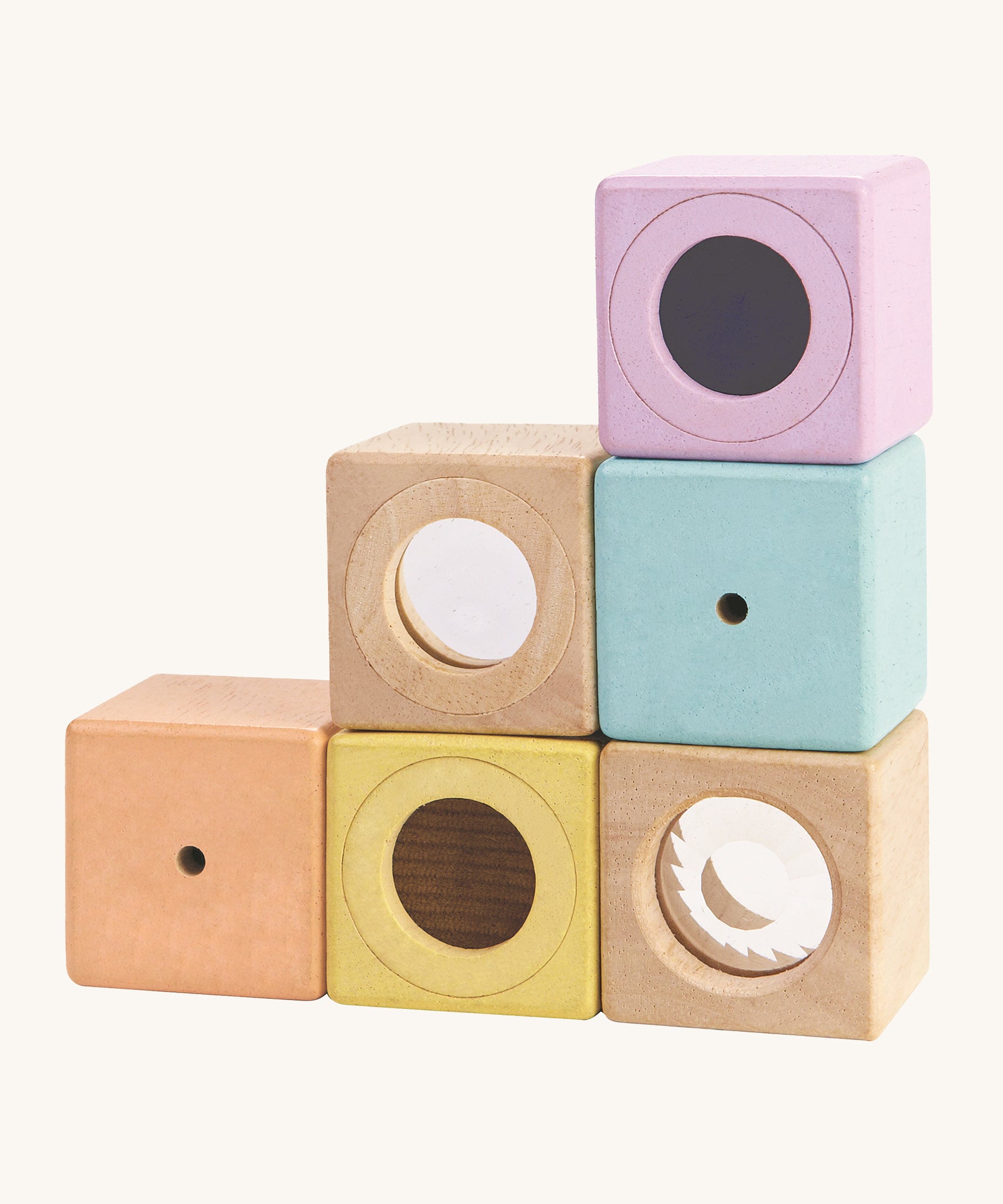 The PlanToys Activity Blocks set, is a wonderful, sensory experience for babies and toddlers. 6 different coluored blocks come with their own sensory part, which includes a differnt texture, sound and colour. These blocks can also be used for stacking games. The image is on a cream background.