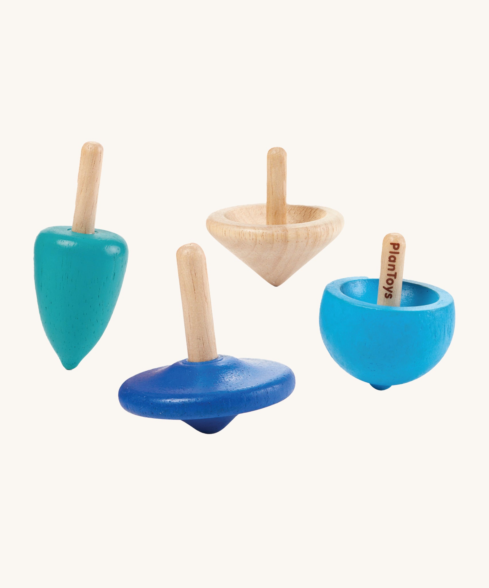 PlanToys Mini Spinning Tops Set of 4 spinning tops in blue shades and natural wood. The spinning tops come in various shapes and are on a cream background