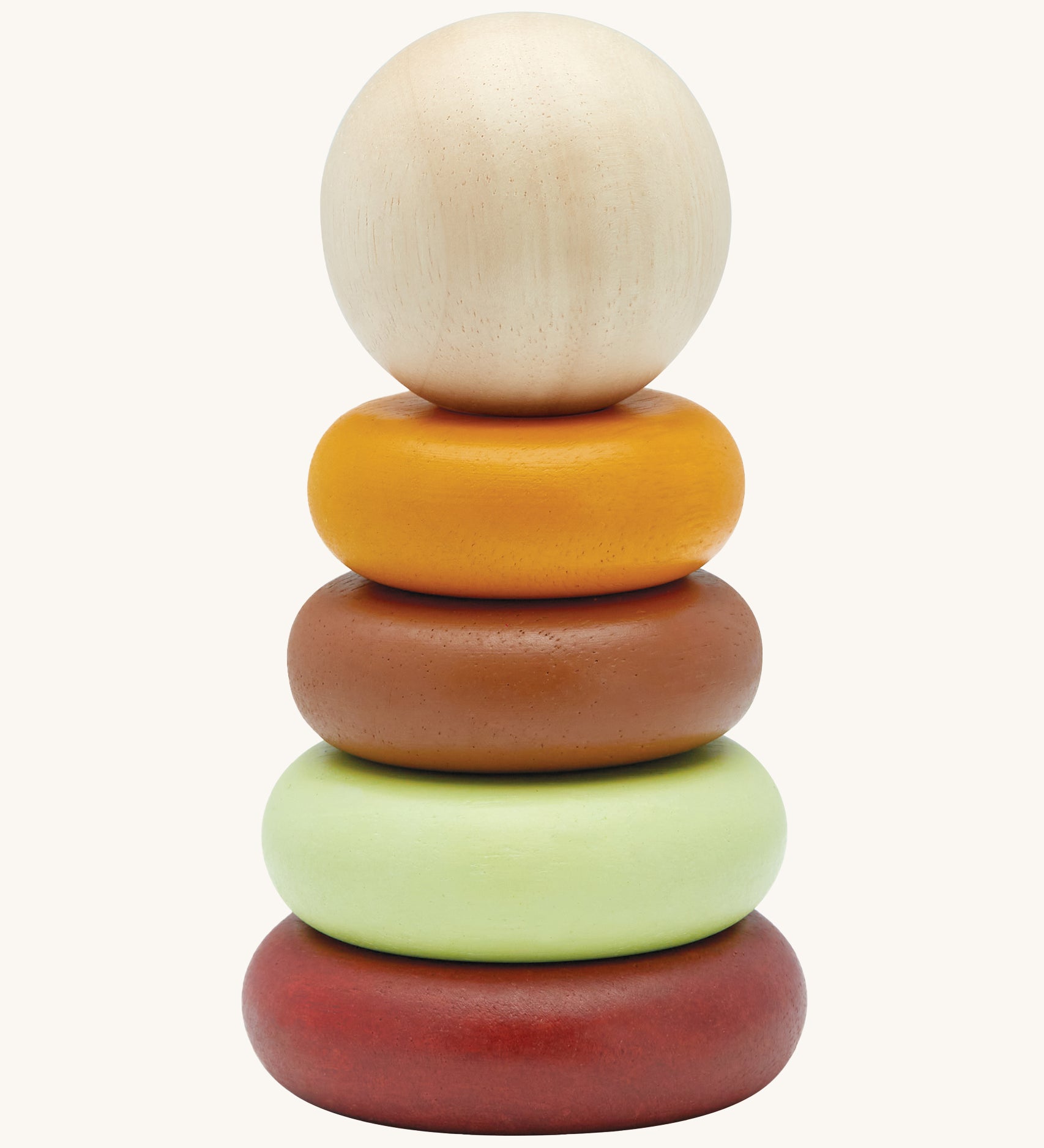 The PlanToys childrens plastic-free wooden Stacking Rings toy in the modern rustic colours on a cream background. The stakcing toy comes with a red base, a green ring, a brown ring, a yellow ring and a natural wood coloured ball on top.