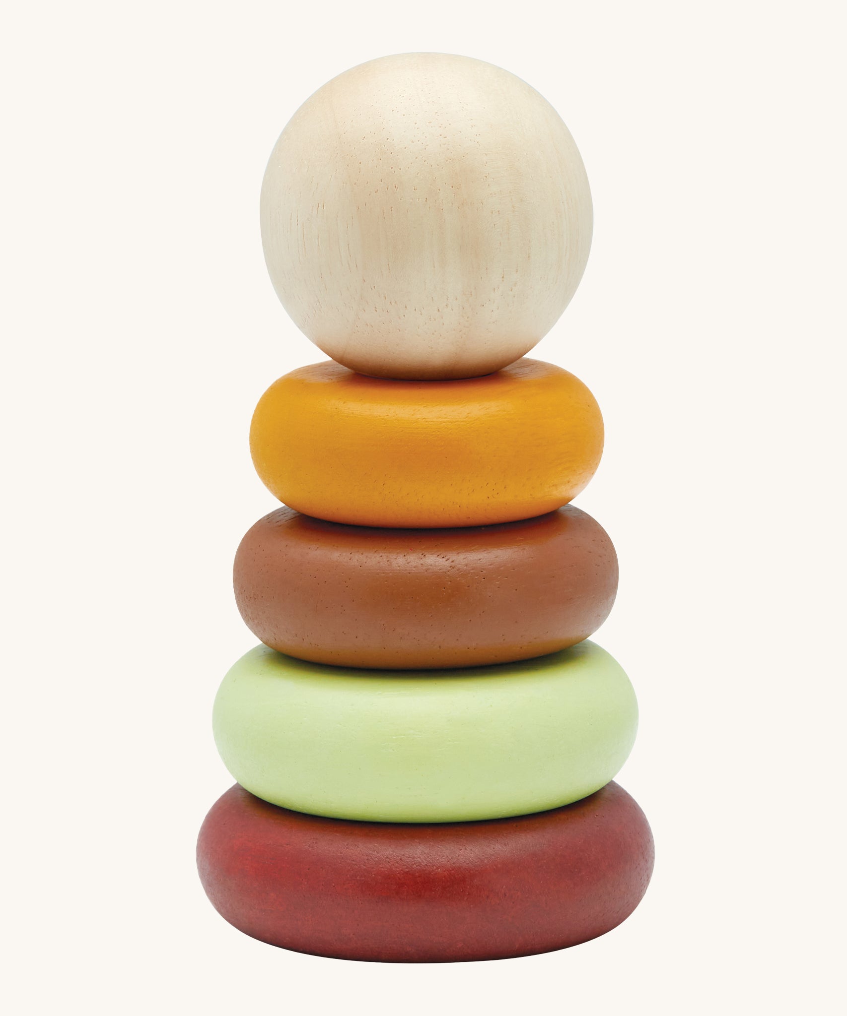 The PlanToys childrens plastic-free wooden Stacking Rings toy in the modern rustic colours on a cream background. The stakcing toy comes with a red base, a green ring, a brown ring, a yellow ring and a natural wood coloured ball on top.