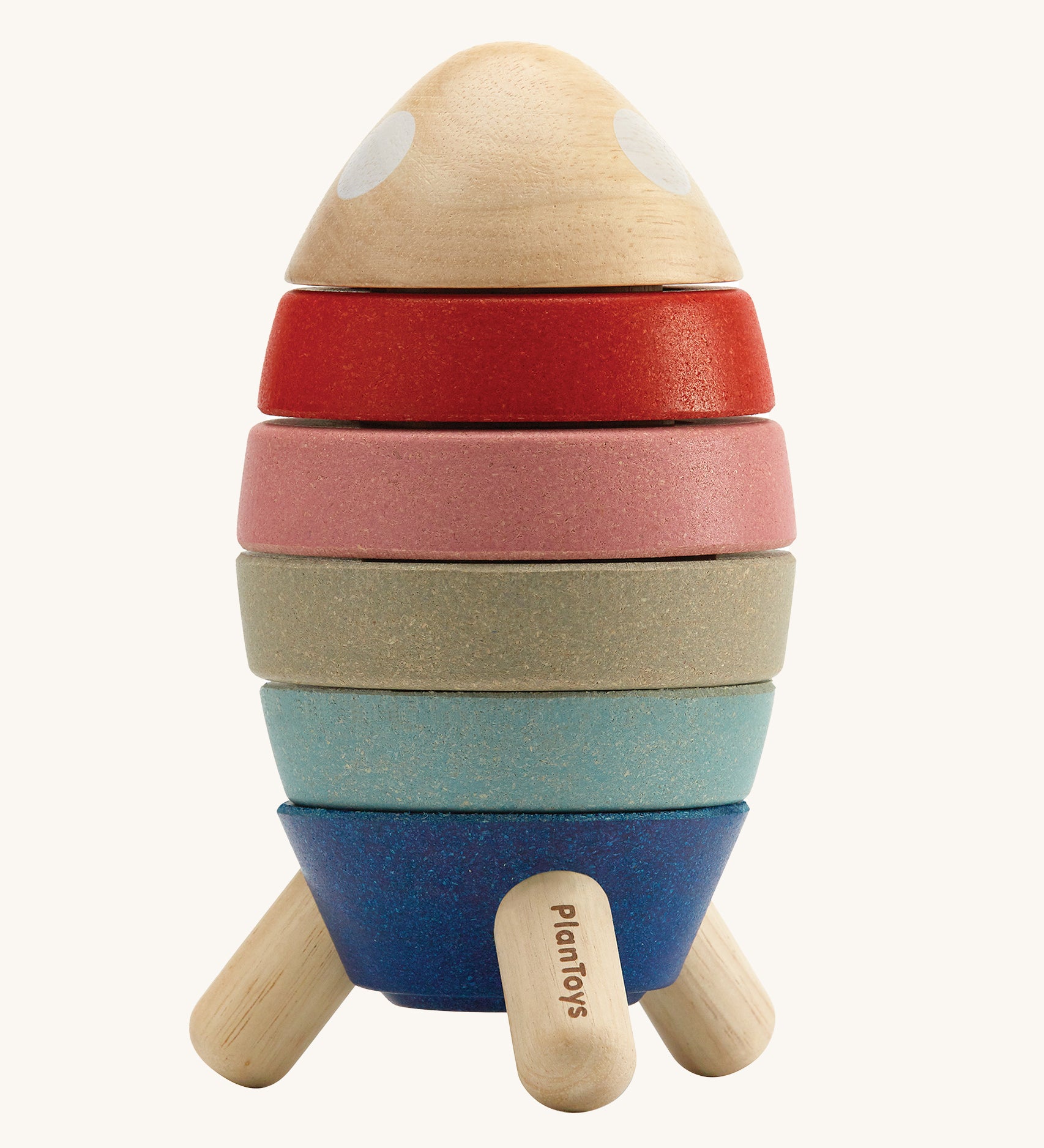 Plan Toys Wooden Stacking Rocket Orchard, has four coloured discs that make up the rocket, each with a cut out for a shape to go into, and a cute little astronaut who hides inside. The image is on a cream background