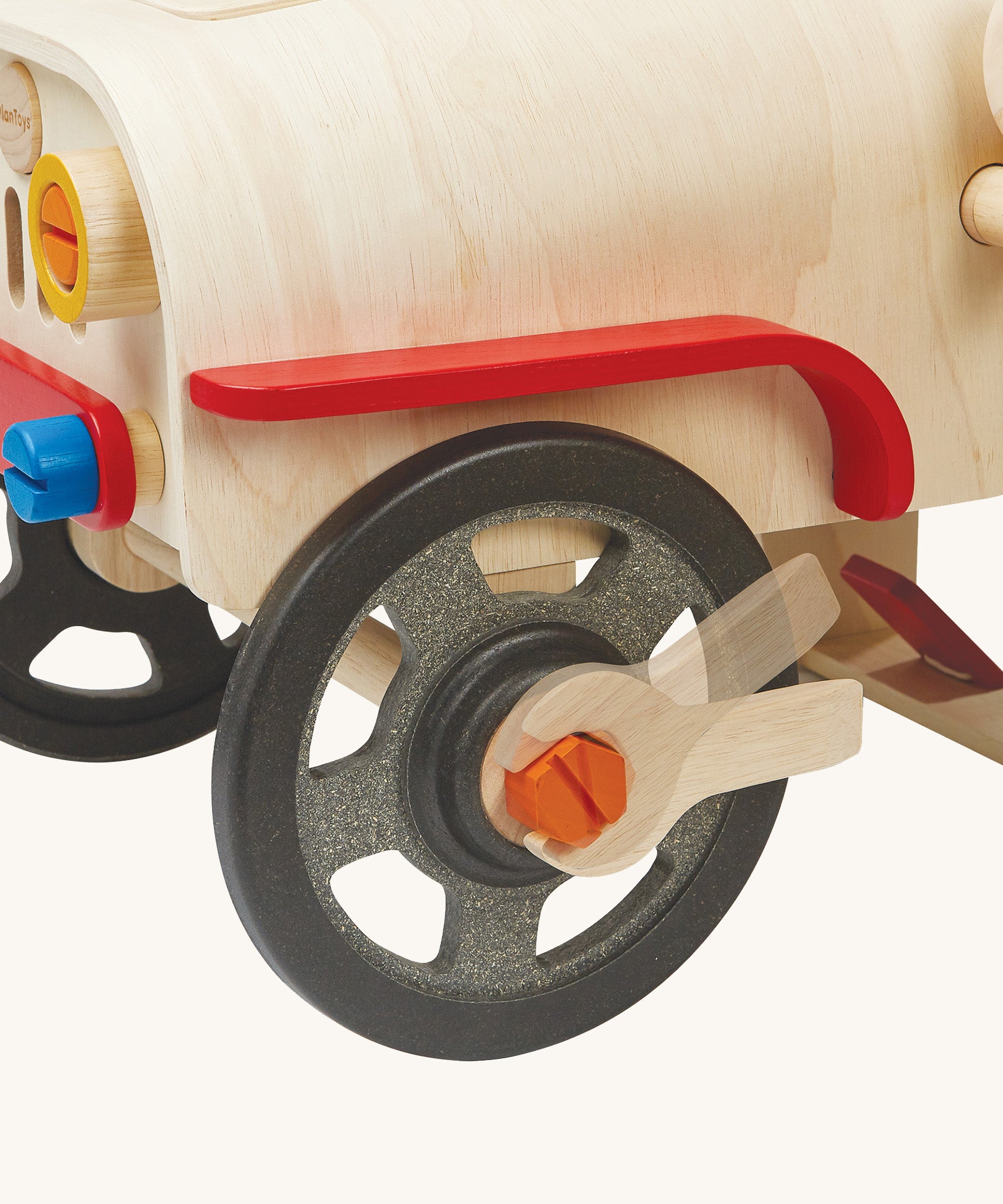 A closer look at the wheel on the PlanToys Motor Mechanic. The wrench is being used to show how to loosen and tighten the wheel bolt