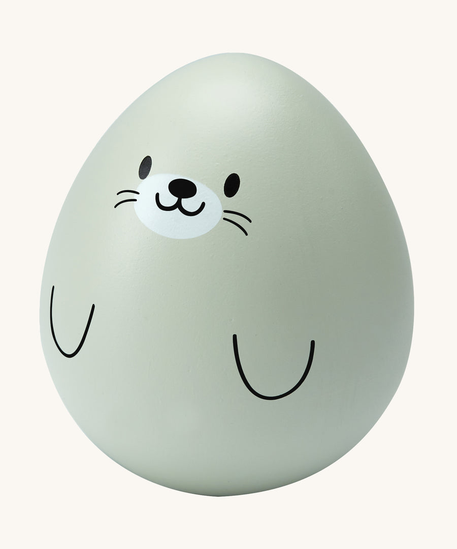 The PlanToys wooden wobbly seal baby toy is an adorable wobble toy which babies and little ones will have so much fun playing with. The egg shaped wobble toy is in light grey with a cute seal face and two black line flippers. The image is on a cream background