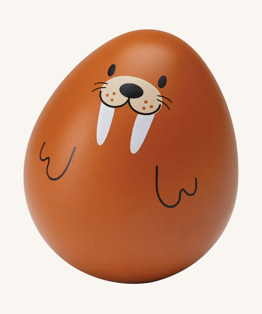 The PlanToys wooden wobbly walrus baby toy is an adorable wobble toy which babies and little ones will have so much fun playing with. The egg shaped wobble toy is in light brown with a cute walrus face and two black line flippers. The image is on a cream background