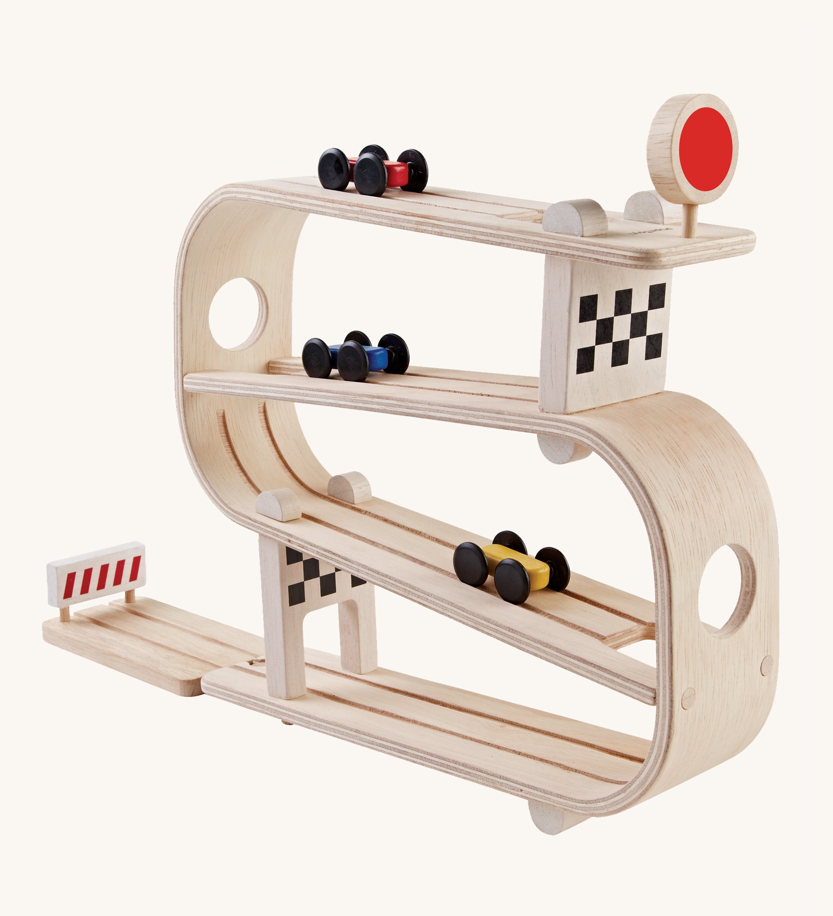 PlanToys Ramp Racer is a wooden car multi-level track with 3 cars, which flip from one track to another. There is a red sign with a circle on the top track, a checkered block on the second and last tack, and a red stop section at the bottom to stop the cars from rolling away. The image is on a cream background