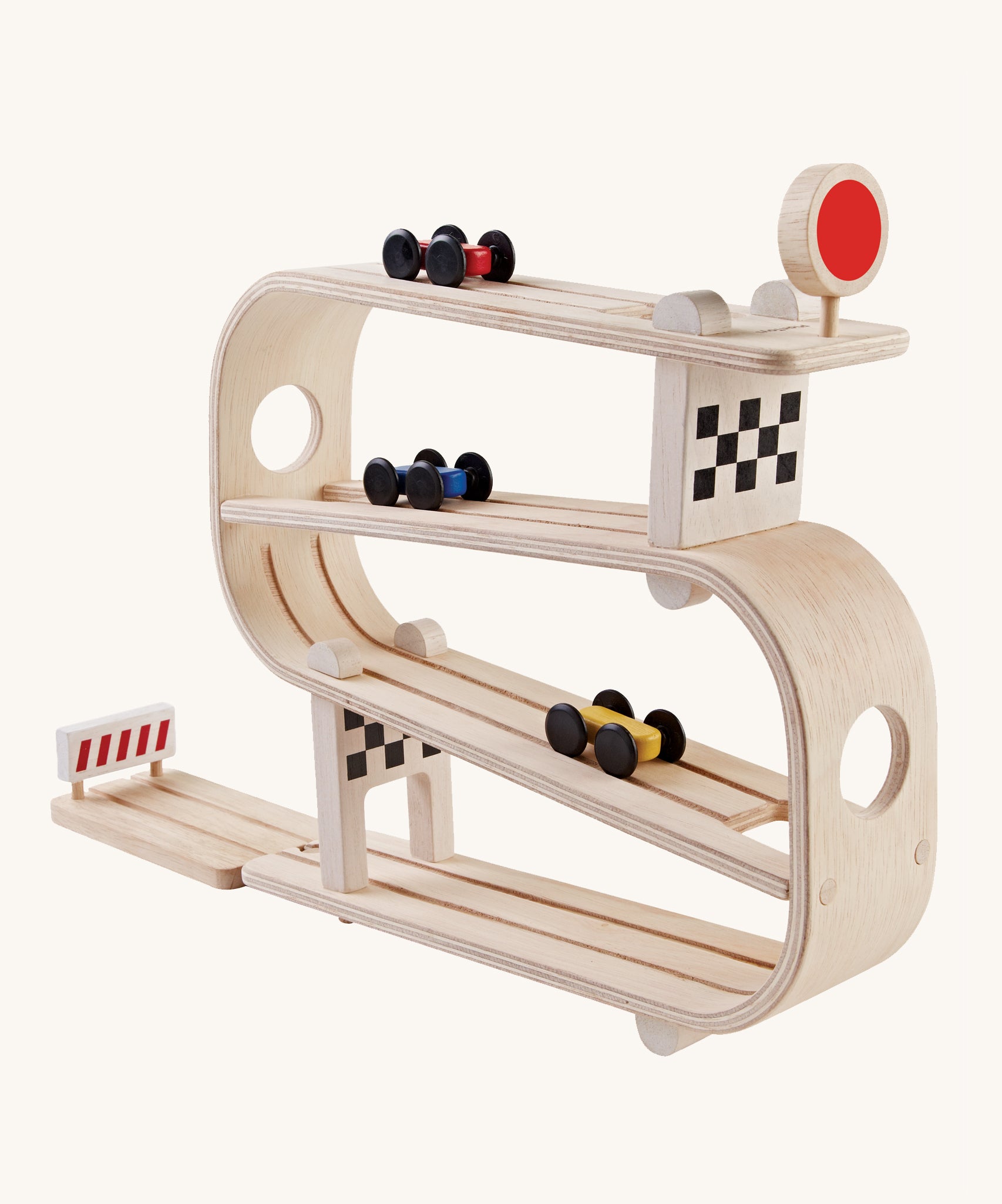 PlanToys Ramp Racer is a wooden car multi-level track with 3 cars, which flip from one track to another. There is a red sign with a circle on the top track, a checkered block on the second and last tack, and a red stop section at the bottom to stop the cars from rolling away. The image is on a cream background