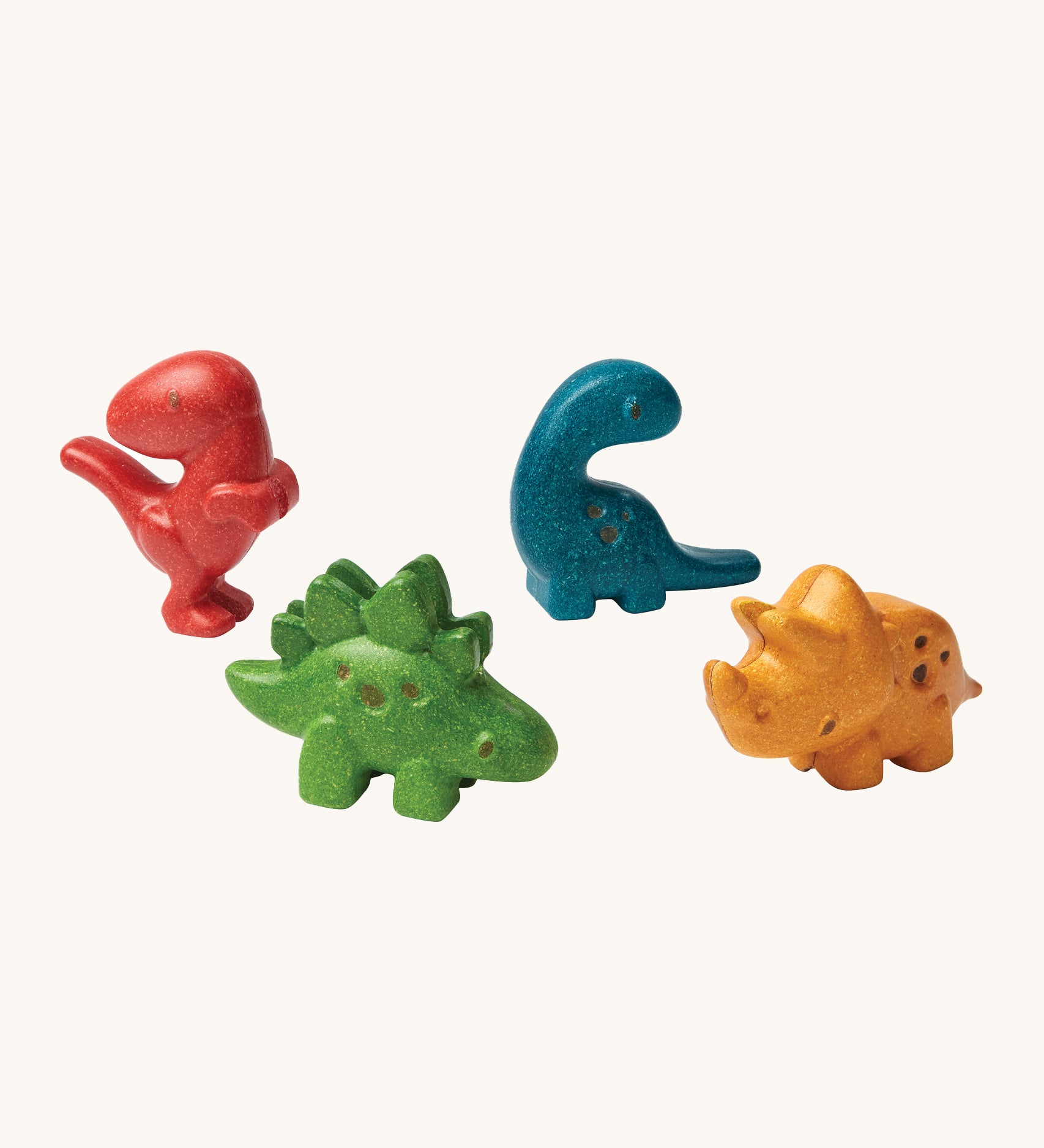 PlanToys Dino Set has 4 adorable dinosaurs. One in red, blue, green and yellow, all made to look like a mini dinosaur. The image is on a cream background