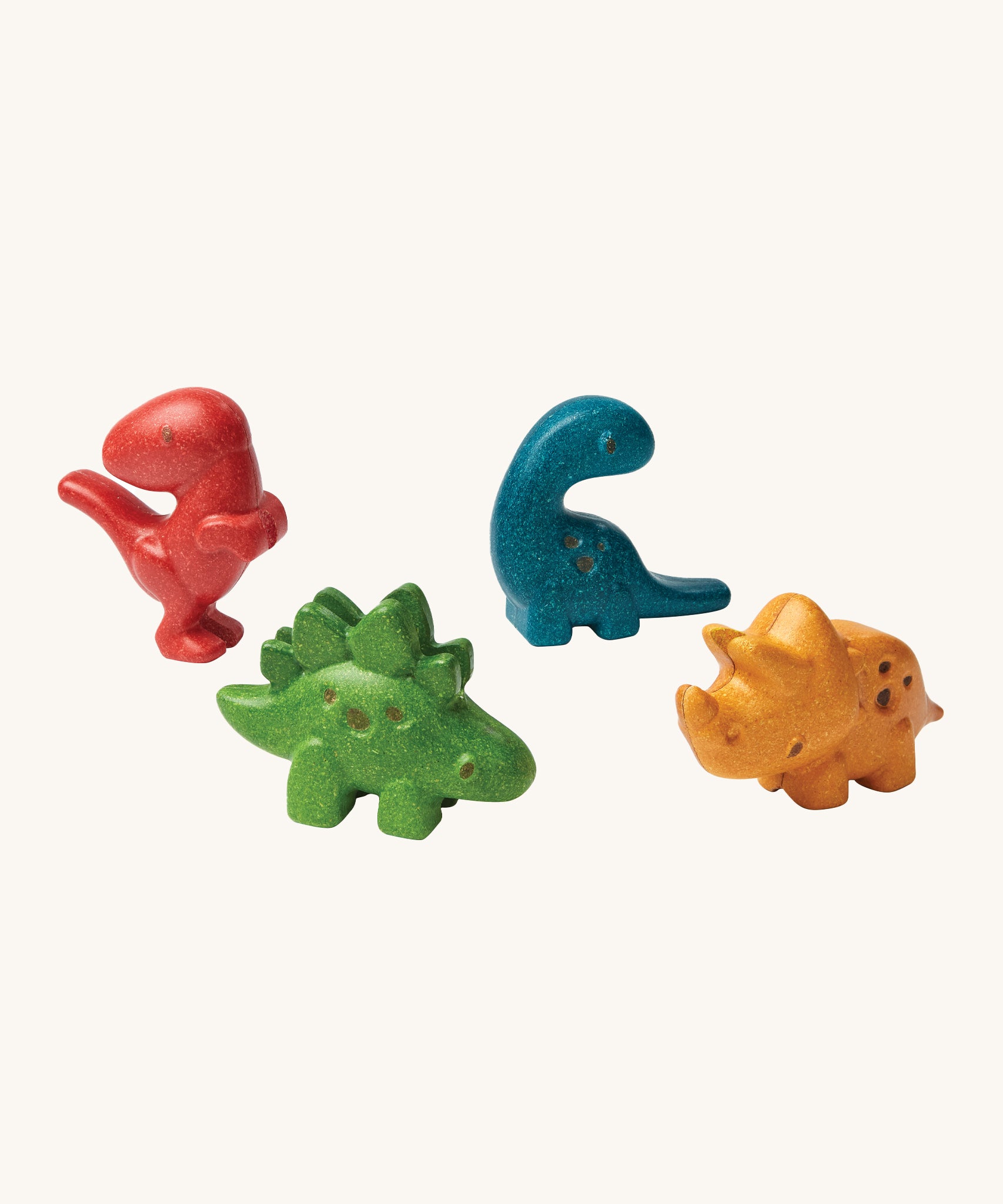 PlanToys Dino Set has 4 adorable dinosaurs. One in red, blue, green and yellow, all made to look like a mini dinosaur. The image is on a cream background