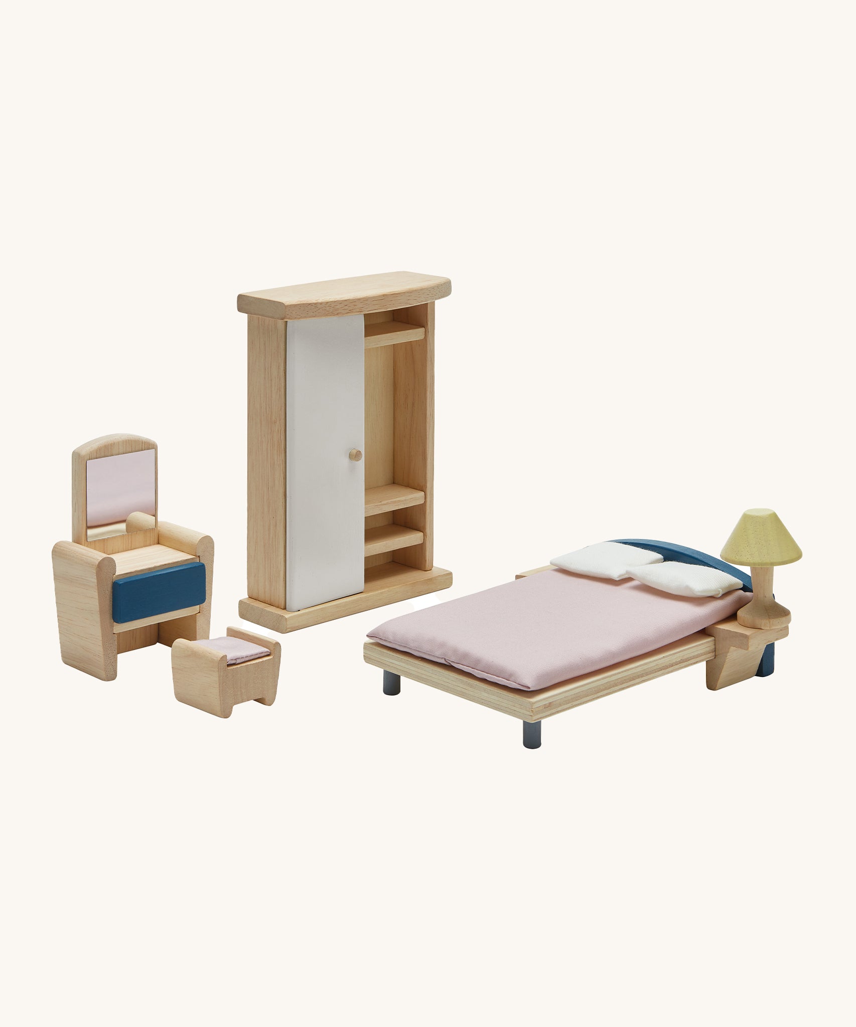 The PlanToys Wooden Dolls House Bedroom Furniture set, featuring a Wardrobe, a chair, a foot stool and bed and a bedside lamp. On a cream background