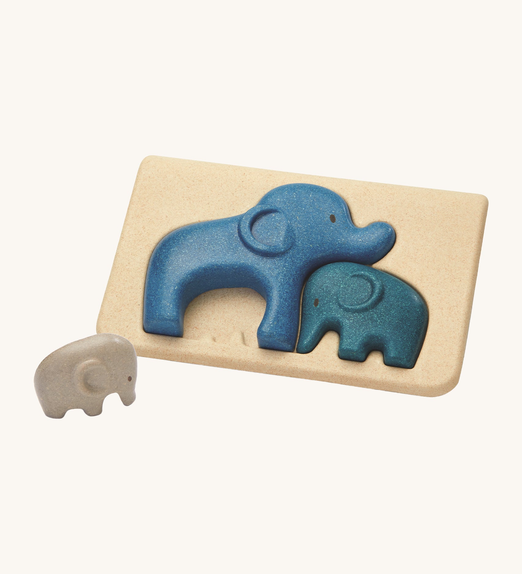 PlanToys Elephant Puzzle on a plain background, the smallest grey coloured elephant can be seen taken out of the puzzle base. 