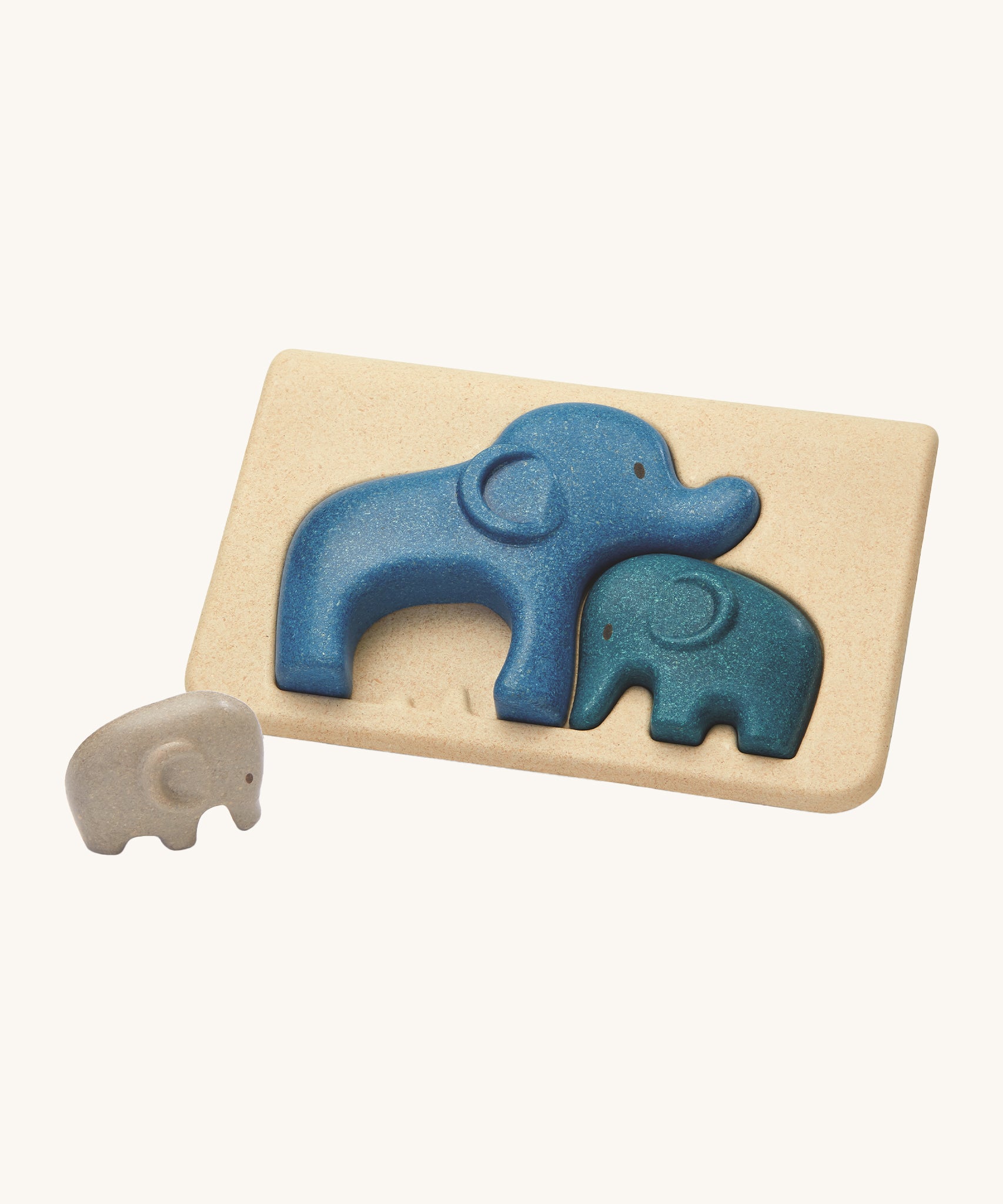 PlanToys Elephant Puzzle on a plain background, the smallest grey coloured elephant can be seen taken out of the puzzle base. 