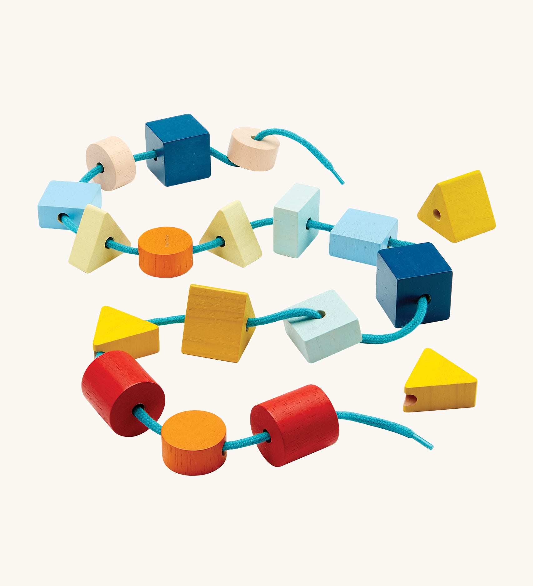 PlanToys children's wooden geo lacing blocks laid out on a cream background. The image shows wooden bead blocks in various colours and shapes, threaded on a light blue shoe string