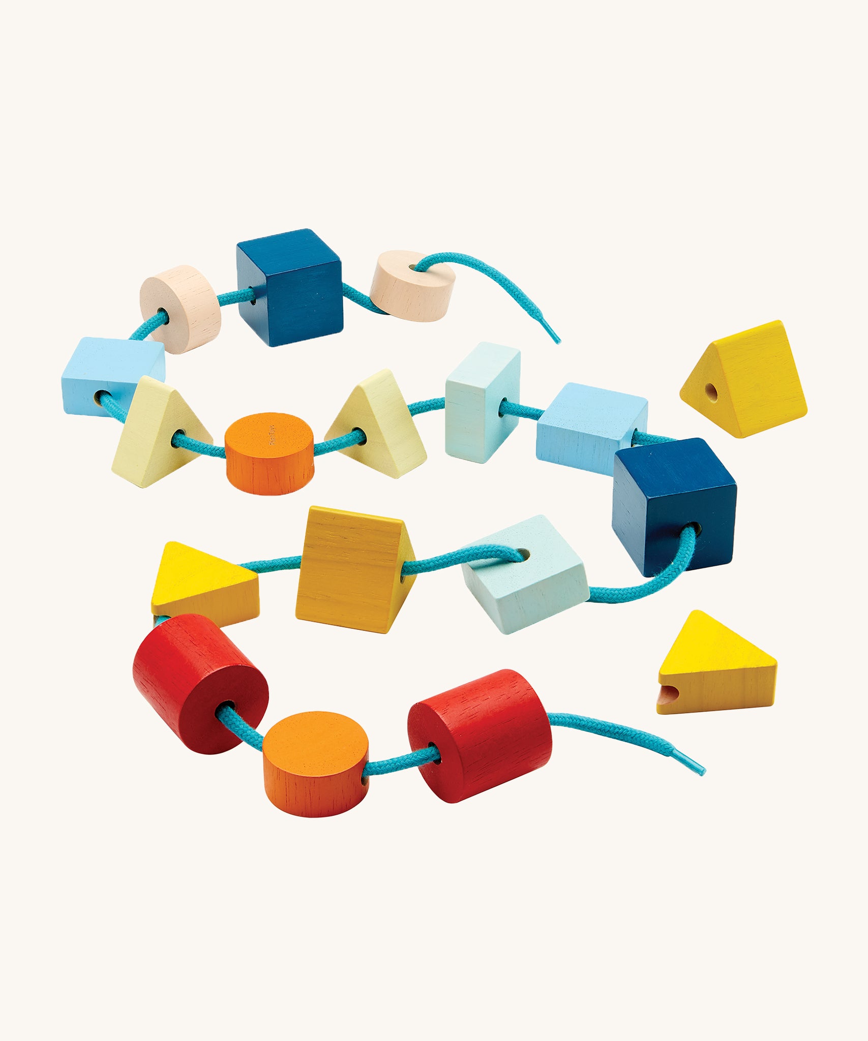 PlanToys children's wooden geo lacing blocks laid out on a cream background. The image shows wooden bead blocks in various colours and shapes, threaded on a light blue shoe string