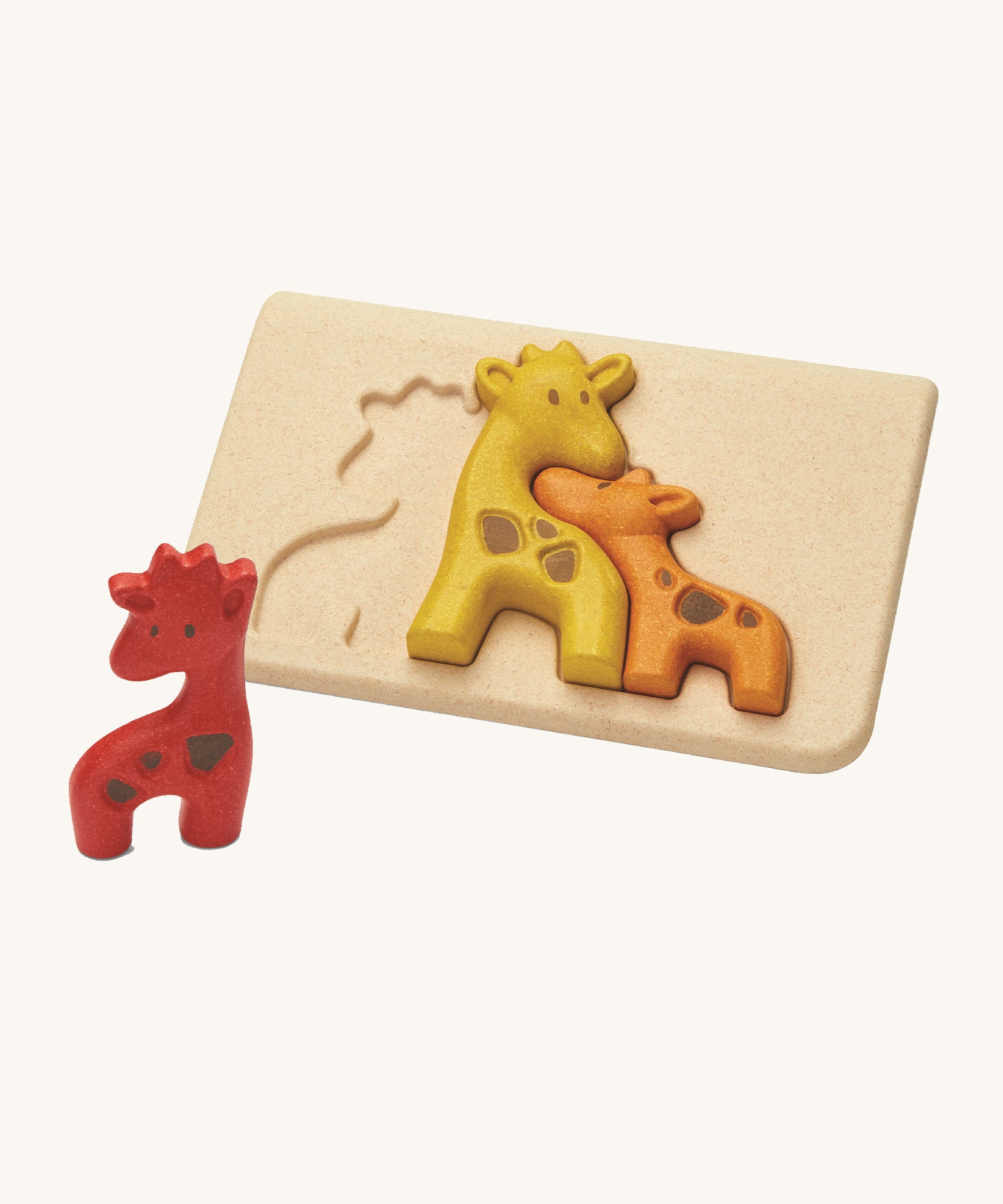 The PlanToys Giraffe Puzzle is an adorable puzzle for little ones. The set comes with a red, a yellow and an orange giraffe which when put together in the puzzle board, look like they're all nuzzling together. The image is on a cream background