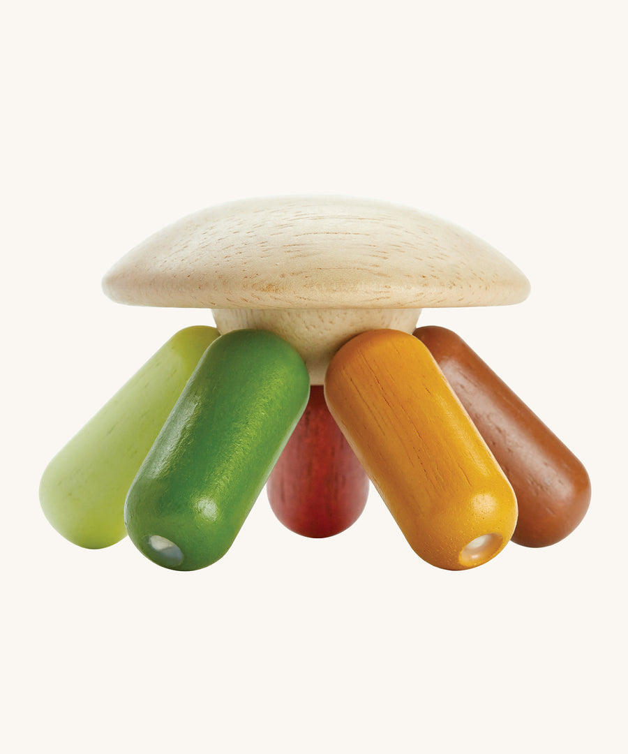 PlanToys plastic-free wooden flexi jellyfish shaped baby sensory and rattle toy in the modern rustic colours of, greens, yellows and browns, on a cream background