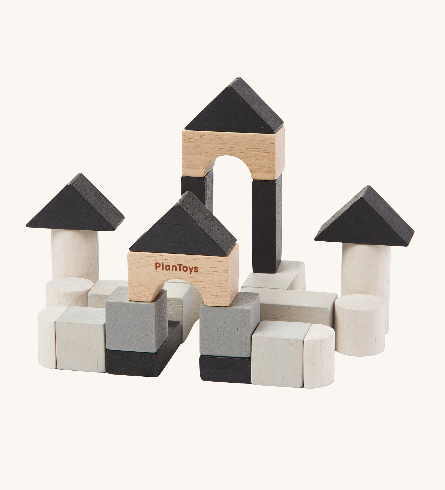 The PlanToys Mini Construction Set with various shaped blocks in shades of grey, black and natural colours on a cream background