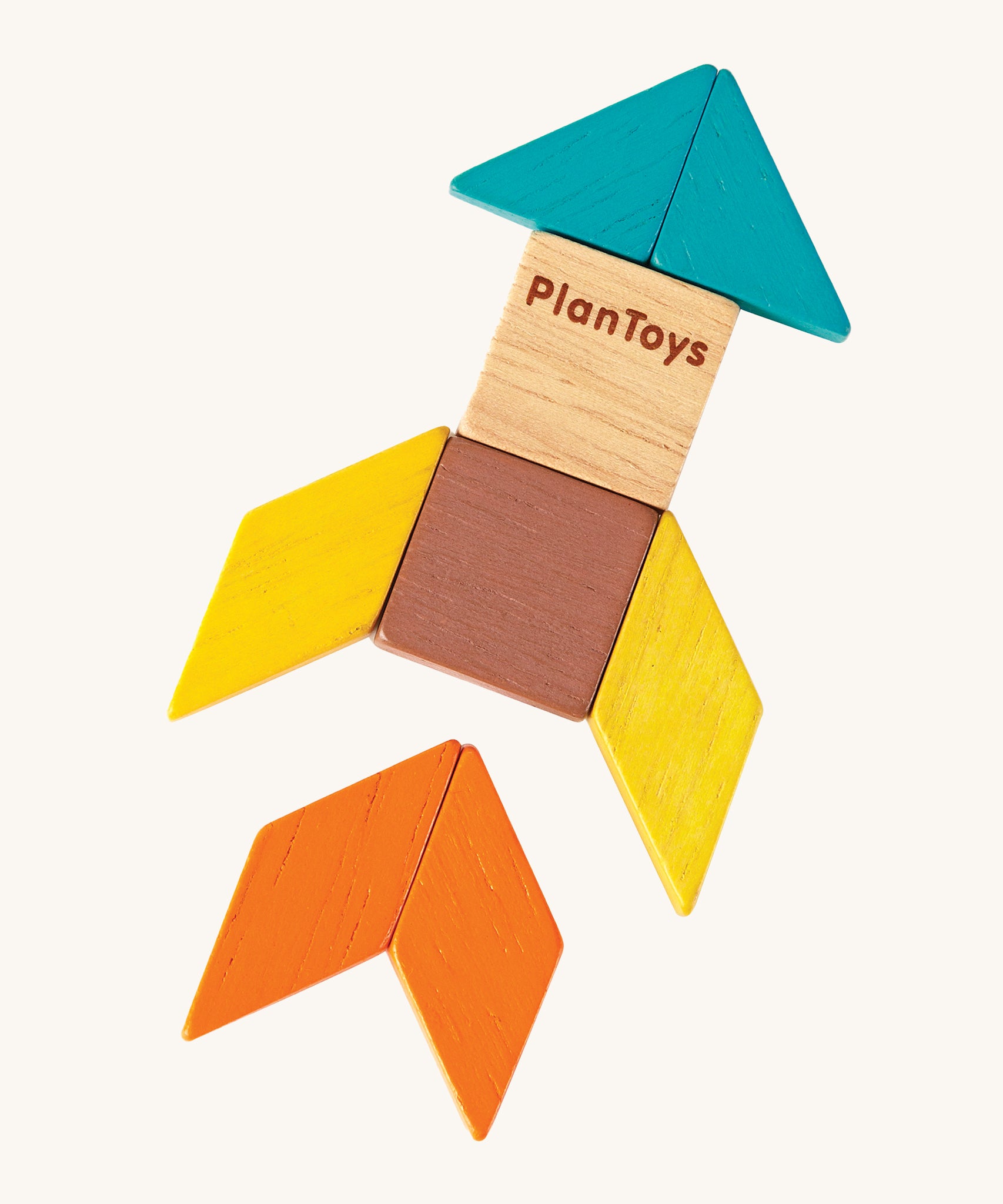 A rocket ship made from the shapes of the PlanToys Mini Mosaic Blocks, on a cream background