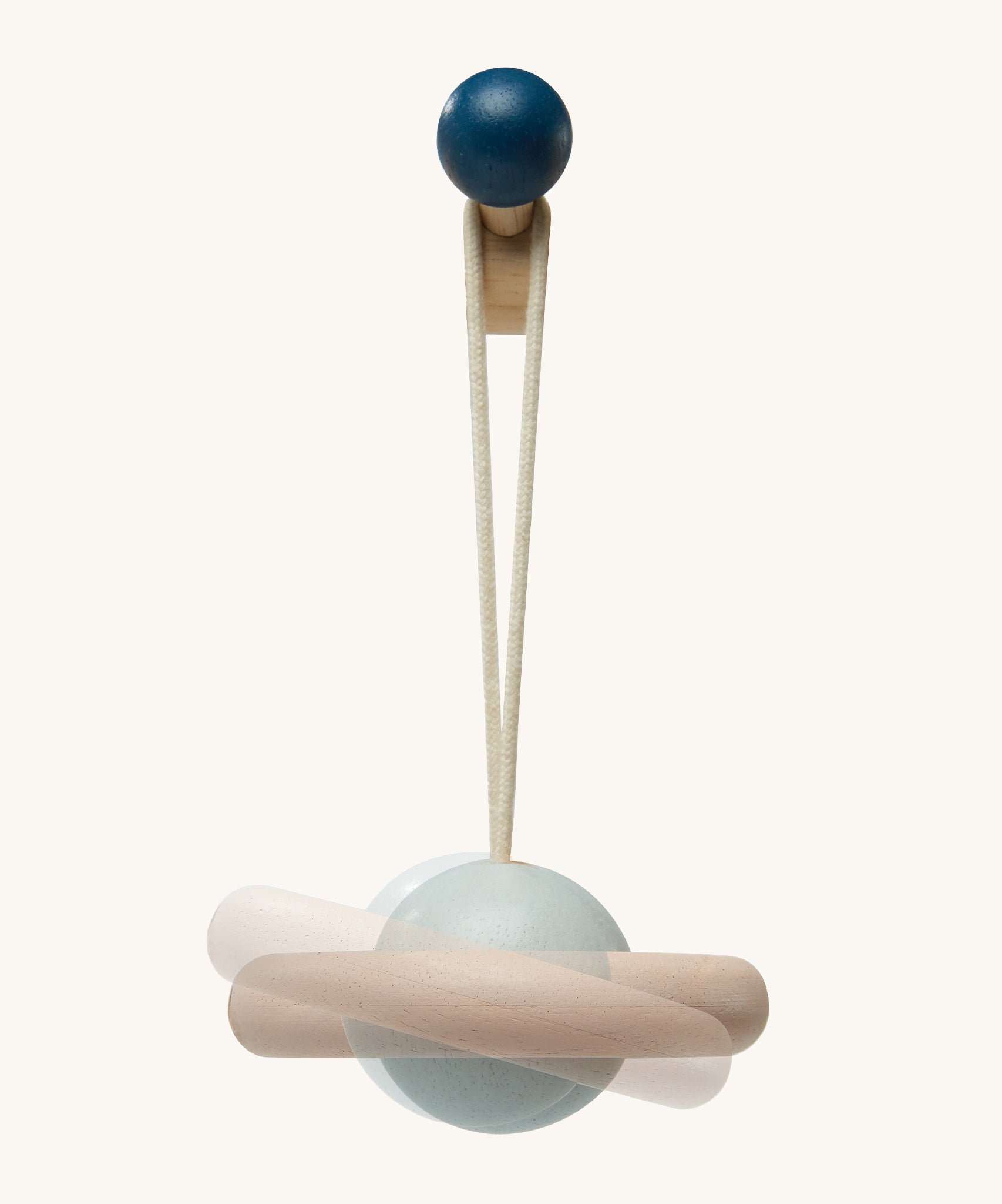 A closer view of the plant toy from the PlanToys Play Gym in Orchard. The planet is light blue with a natural wooden ring around it, and the image has a second, faded image behind it to show the movement of the toy.