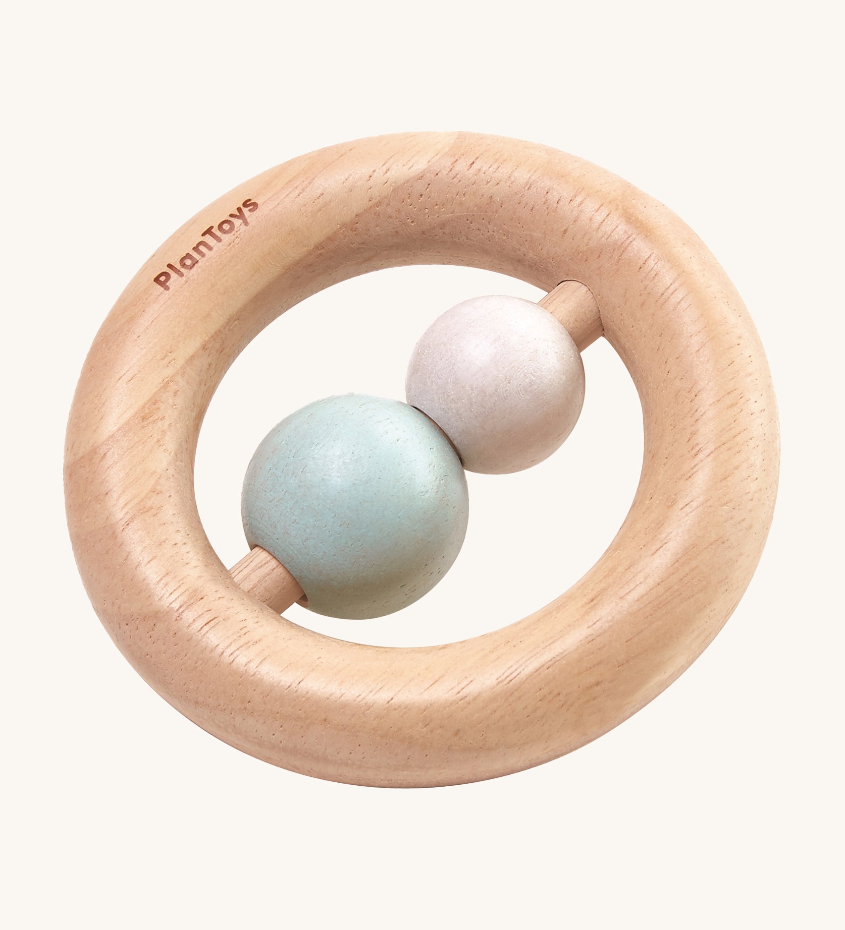 The PlanToys Pastel Ring Rattle is a natural wood ring rattle, with 2 pastel coloured beads in the centre. This ring shape baby rattle is easy for little fingers to grasp, and the 2 beads give a satisfying rattle when shaken. The image is on a cream background