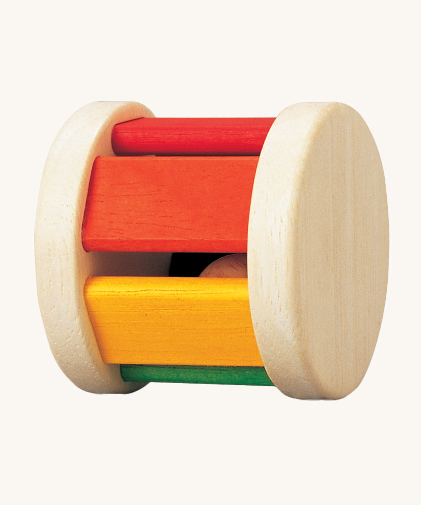 The PlanToys Pastel Roller, is a fun push and pull roller toy for babies and little ones. The roller comes with two natural wooden sides, with rainbow coloured slats, there is also a little wooden ball inside for an auditory experience too. The image is on a cream background