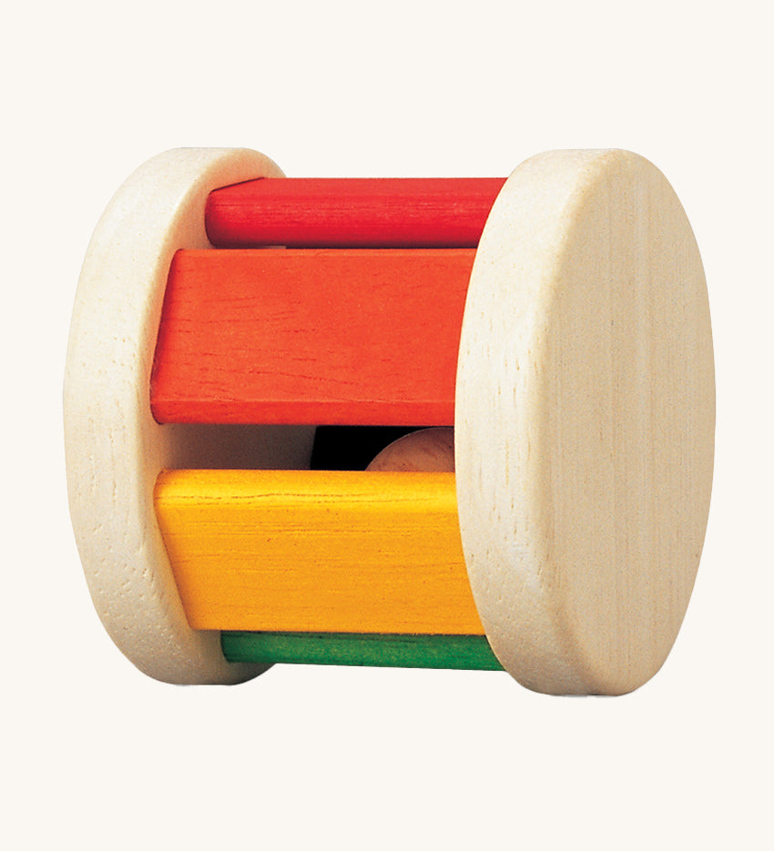 The PlanToys Pastel Roller, is a fun push and pull roller toy for babies and little ones. The roller comes with two natural wooden sides, with rainbow coloured slats, there is also a little wooden ball inside for an auditory experience too. The image is on a cream background