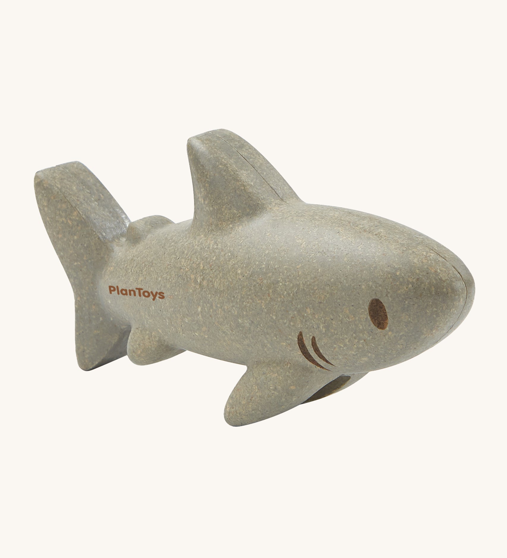 The PlanToys Shark is an adorable sea life toy for little ones. Made from PlanWood, this shark is grey with brown eyes, brown lines for gills, and is on a cream background