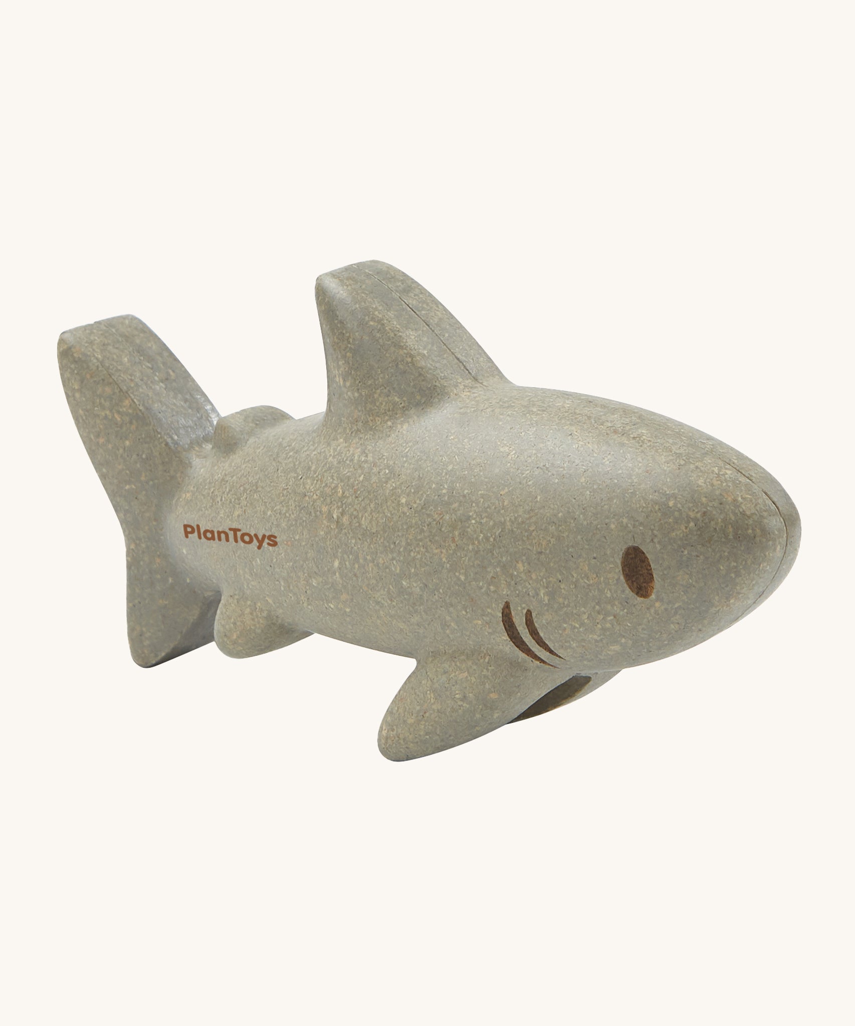 The PlanToys Shark is an adorable sea life toy for little ones. Made from PlanWood, this shark is grey with brown eyes, brown lines for gills, and is on a cream background