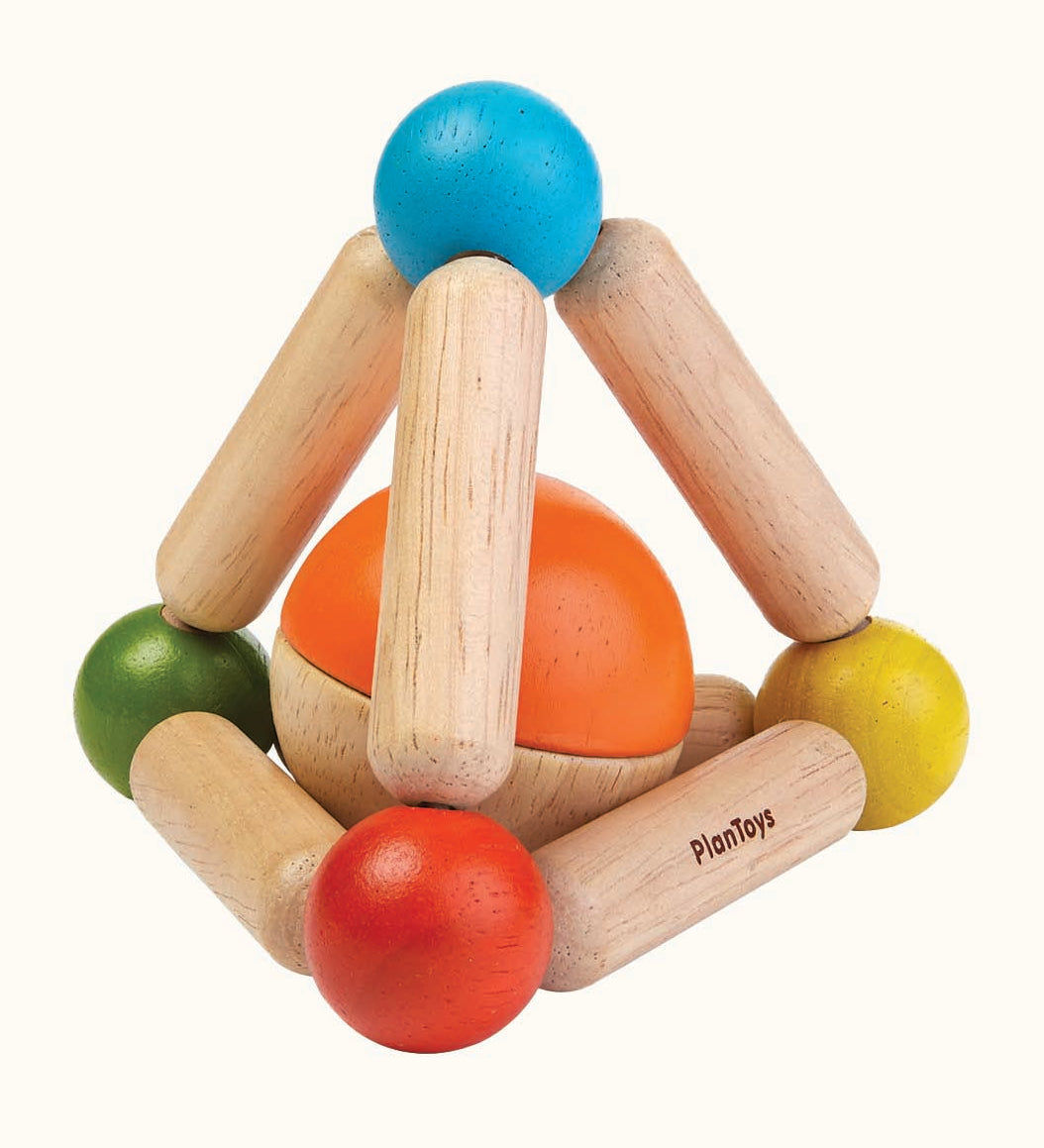 The PlanToys Wooden Triangle Clutching Toy, is a fun and interactive toy for babies and little ones. This sensory toy from PlanToys is made up of a flexible pyramid made up from wooden lengths and painted beads in the colour blue, red, green and yellow, with a chunky ball inside, which can be removed to be played with separately. The image is on a cream background