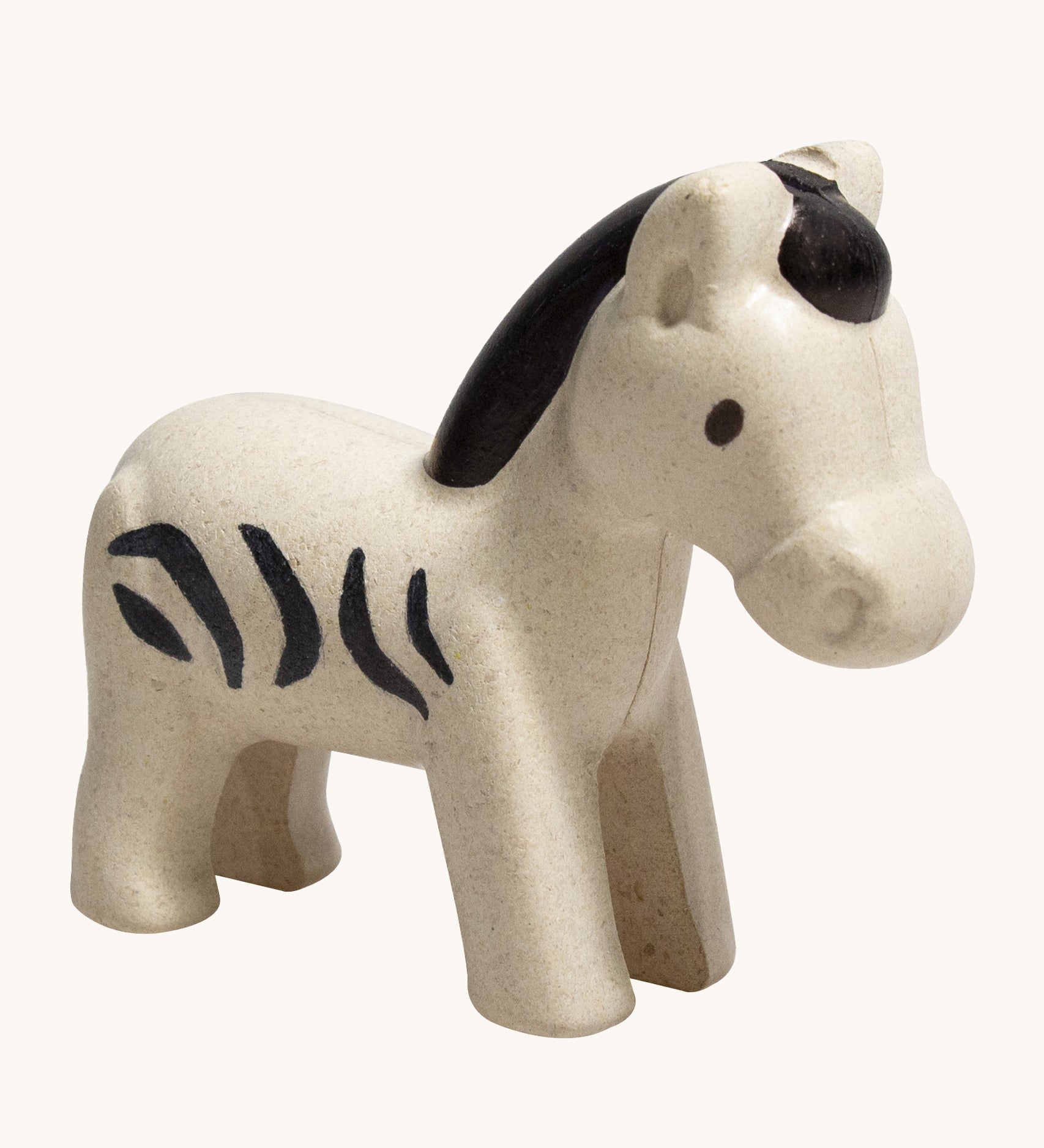 The PlanToys Zebra is an adorable wild animal toy for little ones. Made from PlanWood, this zebra is white with black stripes, a black mane and eyes , and is on a cream background